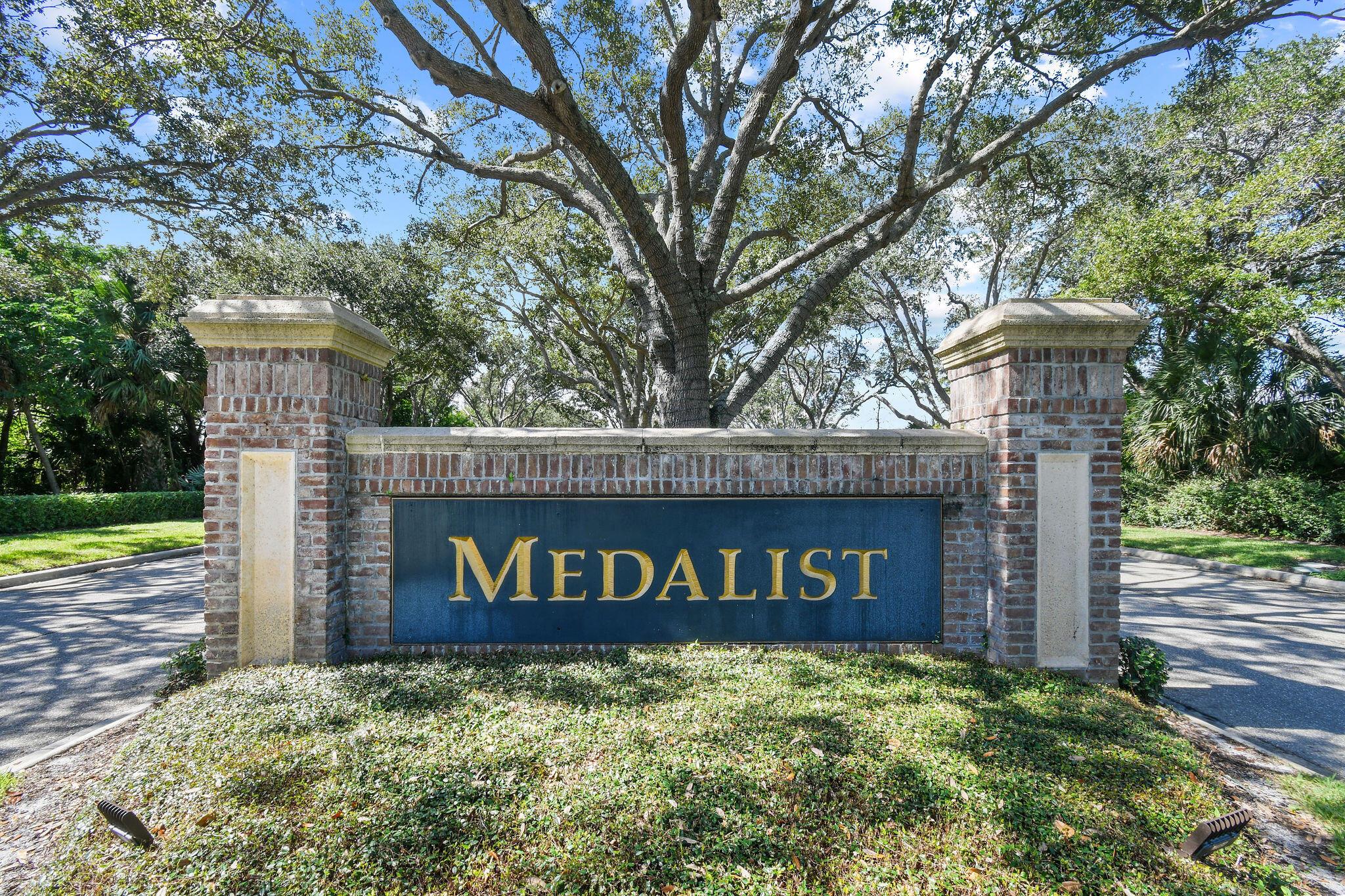 Welcome to the prestigious Medalist Golf Community, where luxury meets nature! Surrounded by 870 acres of untouched Florida preserve, this gated enclave offers privacy and resort-style living. The Medalist Village features a 12-hole Par 3 course, Har-Tru tennis courts, fitness center, spa, and an Australian-inspired pub. This 4BR/4BA courtyard home includes a private separate guest suite, saltwater pool, and paved courtyard--perfect for entertaining. Highlights include 12-ft ceilings, open-concept living, bamboo flooring, and pool views from nearly every room. Bordered by preserve on two sides for exceptional privacy. Additional upgrades include a new metal roof (2023), new air-conditioner (2025) whole-house Generac generator, and accordion shutters.