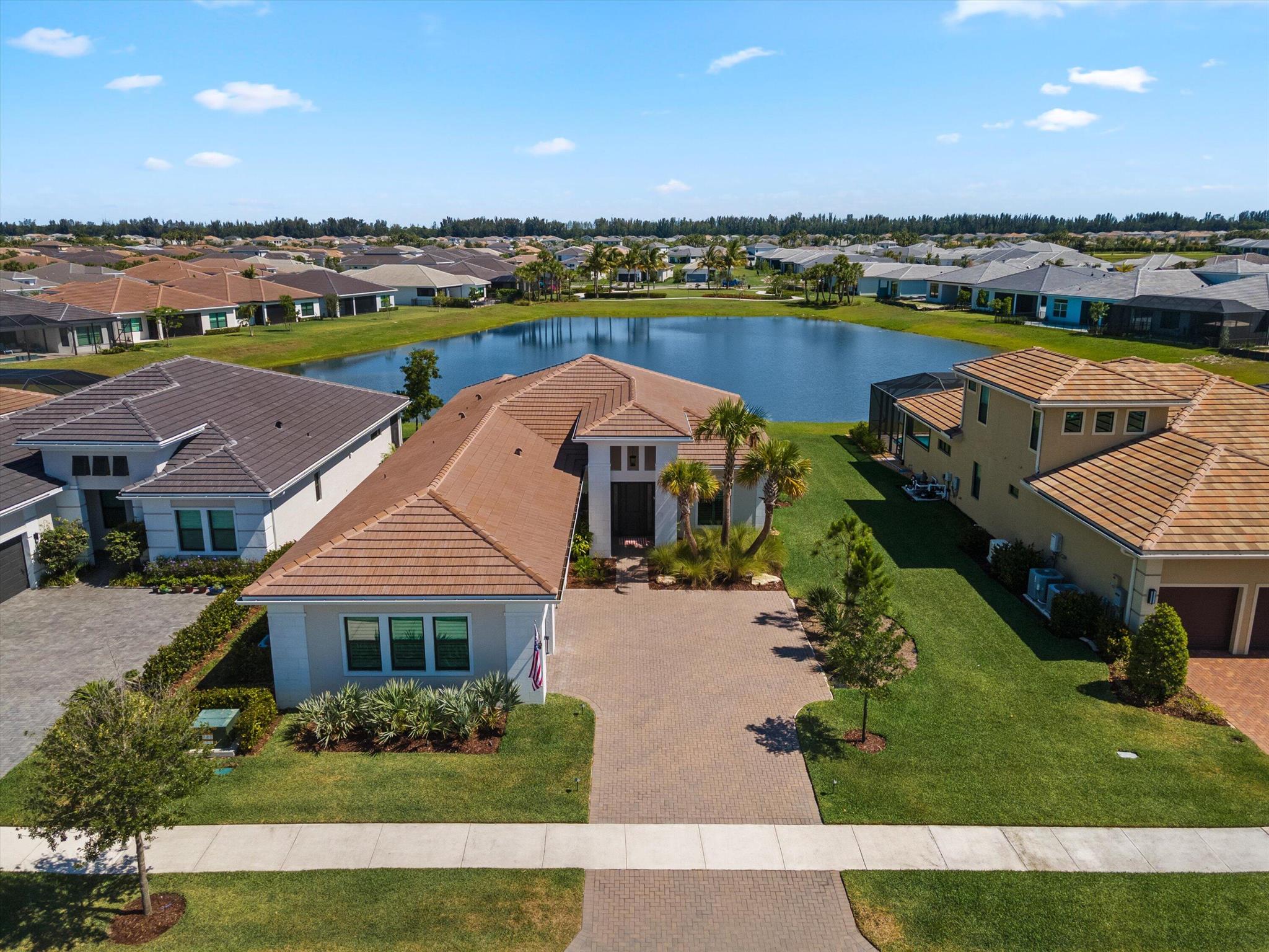 We have relisted this gorgeous Rosemary model in Cresswind Palm Beach with a significant price reduction, offering luxury, flexibility, and lakefront living at an exceptional value. Ideally located in the center of the lake with an easement on the side of the property, this home provides enhanced privacy and some of the community's most desirable water views. Thoughtfully designed with two versatile flex rooms, the first serves as a private office with glass doors, custom shelving, and crown molding, while the second, a glass-enclosed library off the main living area, is perfect as a reading room, studio, or guest retreat. The gourmet kitchen features white soft-close cabinetry, quartz countertops, 36'' gas cooktop with hood, coffee station, walk-in pantry, and an elegant bar with marble