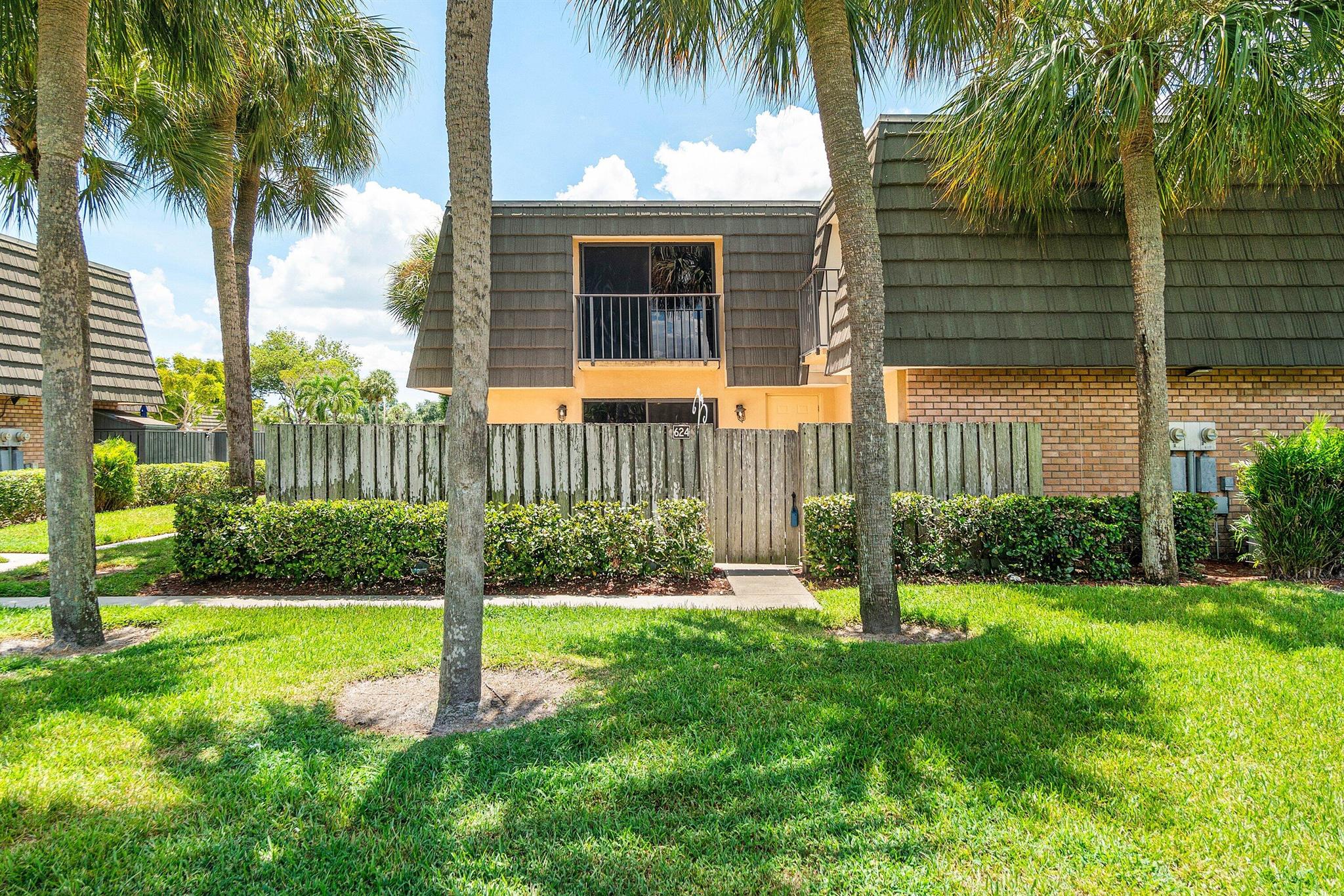 Welcome home to this fully updated 2-bedroom, 2.5-bath townhouse in the highly desirable community of Sandalwood Lakes.Step inside and you'll immediately notice the thoughtful upgrades and modern finishes throughout. The kitchen is a true centerpiece, featuring solid wood shaker cabinetry with under-cabinet lighting, sleek white quartz countertops, an island with bar seating, an oversized sink, a striking glass tile backsplash, and stainless-steel appliances including an oversized refrigerator. Just off the kitchen, a stylish half bath doubles as the laundry room, complete with updated vanity, mirror, hardware, and wood-look tile flooring.The spacious living area offers new fixtures, wood-look vinyl flooring, and an abundance of natural light streaming through large sliding