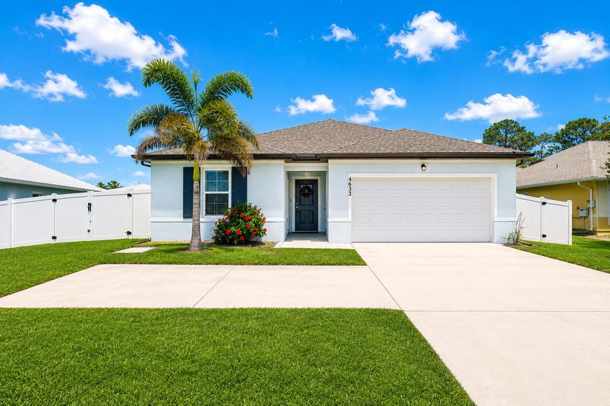 Port St. Lucie CBS Home in a Non-HOA Area between I-95 & the Turnpike! Built in 2022, this high-demand UPGRADED Palmera floor plan offers 4BR | 3BA | 2-Car Garage | SPLIT BEDROOM | APARTMENT SUITE with separate entrance, living room, kitchenette & driveway parking—suited for MULTI-GEN LIVING, GUESTS, BUSINESS SPACE, or RENTAL INCOME. UPGRADES include Luxury PLANTATION Shutters, SHIPLAP accents, built-in FIREPLACE, and DESIGNER CHANDELIER. Luxury finishes include TILE FLOORS throughout and a kitchen with GRANITE countertops, oversized island, 36" cabinets & GE stainless appliances. PRIMARY SUITE features a WALK-IN CLOSET and en-suite bath with dual vanities. Outside is a covered lanai plus VINYL PRIVACY FENCE & DOUBLE GATES on an OVERSIZED 10,000 sq ft lot with room for RV/BOAT.