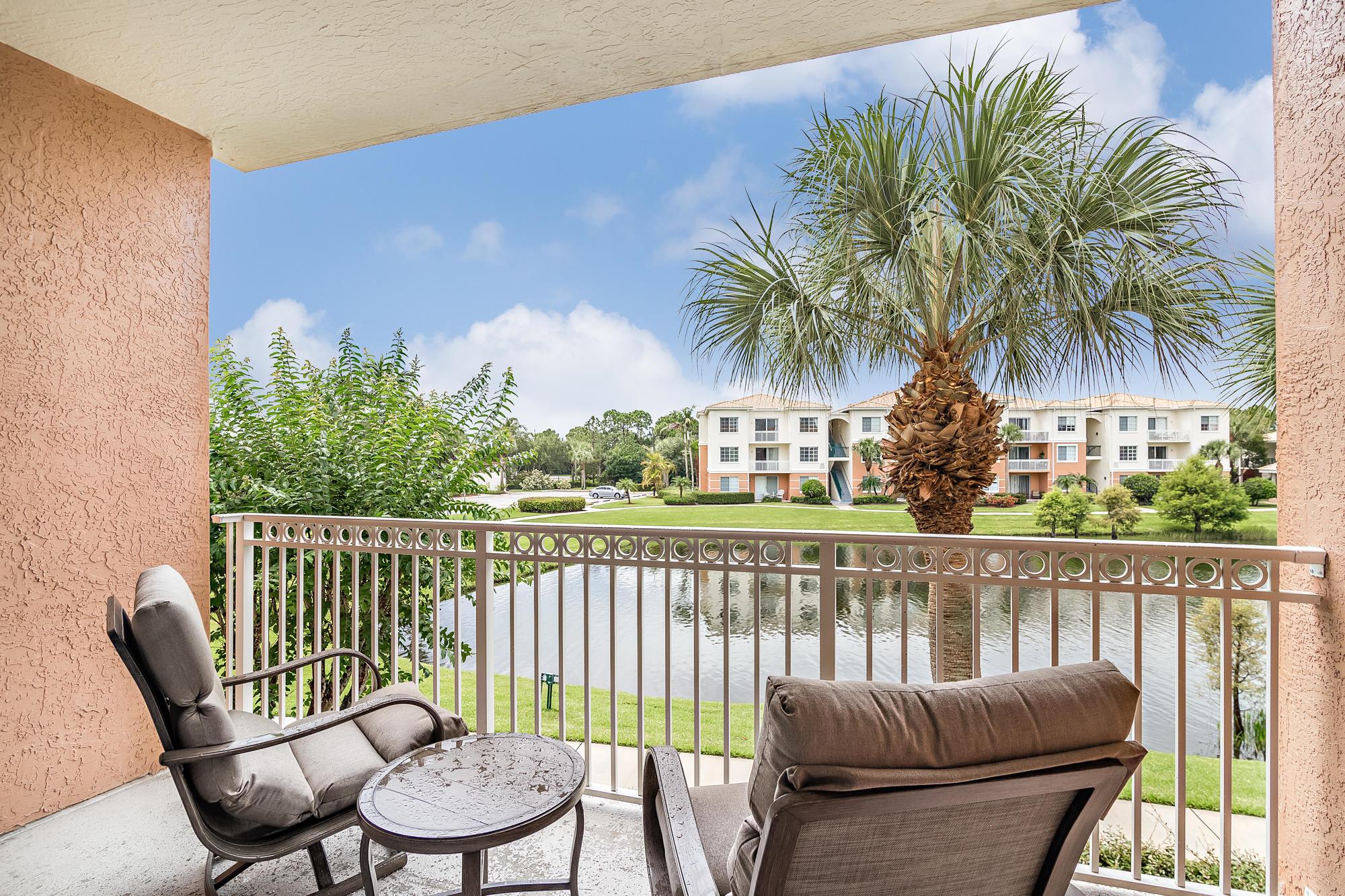 Step into this freshly painted, beautifully upgraded lakefront condo offering 2 spacious bedrooms, 2 full bathrooms, and an attached garage. This light-filled, open-concept unit features elegant engineered hardwood flooring, granite countertops, and a full-size washer and dryer for added convenience. Unwind on the covered patio while enjoying serene lake views. Located on the second floor with southern exposure. Fiore at the Gardens, a high sought after gated community just 5 miles from the beach and close to world-class shopping and dining. Residents enjoy an impressive lineup of resort-style amenities, including a heated pool, clubhouse, cabana, car wash station, putting green, and BBQ grill. Everything you need for relaxed Florida living.