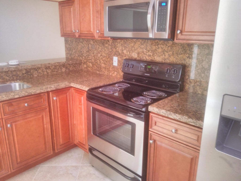 Photo of 3710 Whitehall Drive #103, West Palm Beach, FL 33401 (MLS # B26070345)