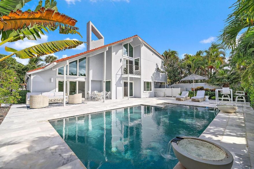 Easy walk to the beach from your front door! Experience luxury coastal living in one of Palm Beach County's most coveted communities. This fully renovated, turnkey residence is ideally situated on a quiet cul-de-sac with desirable southeast exposure and a beautifully landscaped backyard oasis. Boasting 2,642 square feet, the home features 3 bedrooms, 3 baths, and a bright open floor plan enhanced by soaring redone ceilings, a floating staircase, new flooring. Renovated in 2020 by a top designer and high-end remodeling firm, no detail was overlooked-from new Hardie board siding and impact windows to a spacious laundry room and 2-car garage. The custom kitchen is a chef's dream with designer quartz surfaces, custom cabinetry, and premium Wolf, Sub-Zero, and wine refrigeration. The expanded primary suite includes a sitting area, dual balconies, a massive custom closet with island, and a spa-inspired bath with soaking tub and frameless shower.  Step outside to your private retreat featuring a renovated pool with waterfall bowls and color lighting, slip-resistant porcelain patio, tropical landscaping, and a custom walkway. All just moments from Jupiter's pristine beaches, world-class dining and shopping!