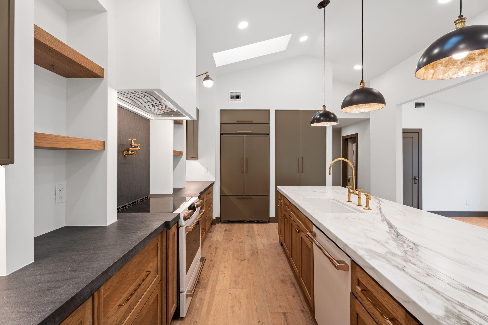 Completely remodeled residence in Mallard Creek, located within the gated Martin Downs Country Club. This 2BR + den / 2BA home features custom kitchen cabinetry, leathered marble counters, a built-in KitchenAid refrigerator, and new Caf series oven and dishwasher. The baths are finished with quartz counters, while the primary suite showcases custom tile work, a soaking tub, and both an indoor and private outdoor shower. Additional highlights include a 2024 concrete tile roof, epoxy-finished garage, and a spacious screened patio. The den currently serves as an office and can be converted to a true third bedroom at buyer's request prior to closing.
