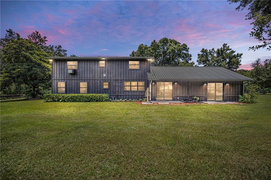 If you have been dreaming of farm life in Florida, WELCOME HOME! 22+ acres (2 parcels) of gorgeous Granddaddy Oaks and open pastures.  Drive through the gated entrance with beautiful draping trees, stunning landscaping, an incredible orchard with several varieties of fruit to this private sanctuary.  This stunning custom renovated pool home is one of a kind.  You will fall in love with the spacious kitchen, large dining area, and huge family room.  Large windows and sliding glass doors provide natural light making it easy to soak up the views.  Enjoy your morning coffee on the back porch and your evenings by the waterfall pool. Welcome to the entertainment barn, built for weddings and special events. Open the double doors of this gorgeous 32 x 60 custom built barn, the beauty of the tongue and grove stained pine with chandelier lighting will take your breath away.  There are two bathrooms with a full kitchen.  Designed with entertaining in mind, it's a stunning space or could easily be converted to a second home.  Attached is a 32 x 60 pole barn with RV hookups including septic.  This could easily be converted to more entertaining space or even a horse barn.  There's a separate office building , metal workshop too.  Out back are several acres of irrigated pecan trees (owner will remove if they are not wanted). Next door is a wide wide open field ready for livestock, pastures or just leave it wide open.  The front part is covered with trees and a walking trail protected from the road for complete privacy.  This property is suited for a variety of disciplines of equine activities but also other possibilities including a popular Farm Wedding Venue, Nursery, or just a tranquil farm for the family.  This must be seen to believe that it's that pretty. Located just 20 minutes from the World Equestrian Center!