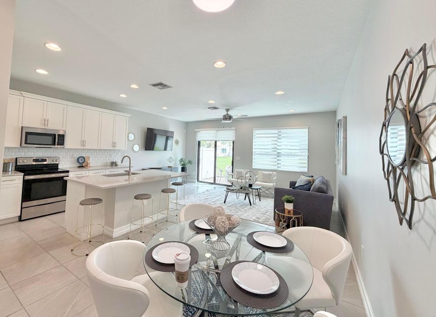 Move-In Ready, Newer 2-Story Townhome with Lake Views in the Resort-Style Community of Enclave At Boca Dunes. This 3Bed/2.5Bath Home Shows like a Model and features High Ceilings, Tile on First Level & Beautiful High End Vinyl Wood Flooring on Stairs & Second Floor. 1-Car Garage with 2-Car Driveway. Open Concept Kitchen with White Cabinetry, GE Stainless Steel Appliances, Granite Countertops and Large Island. Upstairs Master Suite Offers Lake View, Ensuite Bathroom with Double Vanity and Frameless Shower Glass Enclosure. Laundry Room, Bathroom and 2 Additional Bedrooms are also Upstairs. Impact Windows/Doors. Resort-style Amenities including Pool, Spa, Clubhouse, Fitness Center & Playground. Low HOA. Centrally Located in W Boca, near Shopping & Dining. Next to Public Golf Course. Move-In Ready, Newer 2-Story Townhome with Lake Views in the Resort-Style Community of Enclave At Boca Dunes. This 3Bed/2.5Bath Home Shows like a Model and features High Ceilings, Tile on First Level & Beautiful High End Vinyl Wood Flooring on Stairs & Second Floor. 1-Car Garage with 2-Car Driveway. Open Concept Kitchen with White Cabinetry, GE Stainless Steel Appliances, Granite Countertops and Large Island. Upstairs Master Suite Offers Lake View, Ensuite Bathroom with Double Vanity and Frameless Shower Glass Enclosure. Laundry Room, Bathroom and 2 Additional Bedrooms are also Upstairs. Impact Windows/Doors. Resort-style Amenities including Pool, Spa, Clubhouse, Fitness Center & Playground. Low HOA. Centrally Located in W Boca, near Shopping & Dining. Next to Public Golf Course.