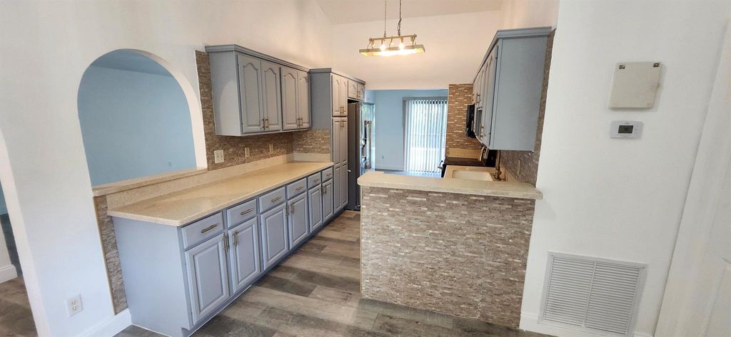 Photo of 301 SW Whitmore Drive, Port Saint Lucie, FL 34984 (MLS # R11121231)