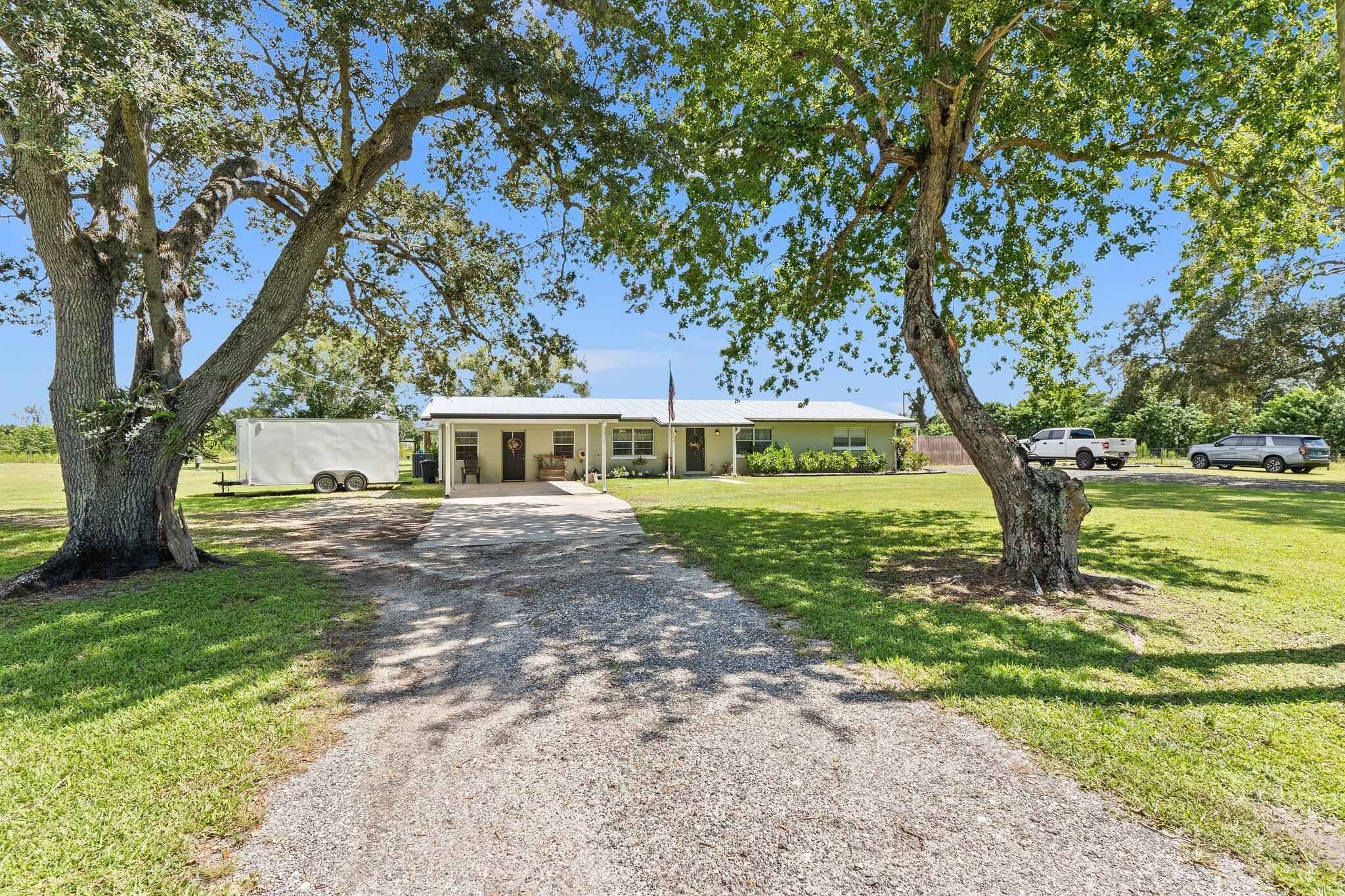 Welcome to country living at 340 N FFA Road in Fort Pierce. This spacious 5-bedroom, 3-bath home sits on just over 2 acres of AG1-zoned land, giving you room to grow, play, and create the lifestyle you've been looking for.Inside, the split floor plan provides comfort and privacy for everyone. The master suite is tucked away on one side of the home, while the additional bedrooms sit on the other--ideal for family, guests, or simply separating your space. The living areas flow easily for gatherings, and the kitchen offers generous counter and cabinet space, ready for everyday cooking or entertaining.A standout feature is the separate entrance, perfect for a home office, in-law suite, or private guest quarters. Whether you're running a business, hosting family, or carving out a