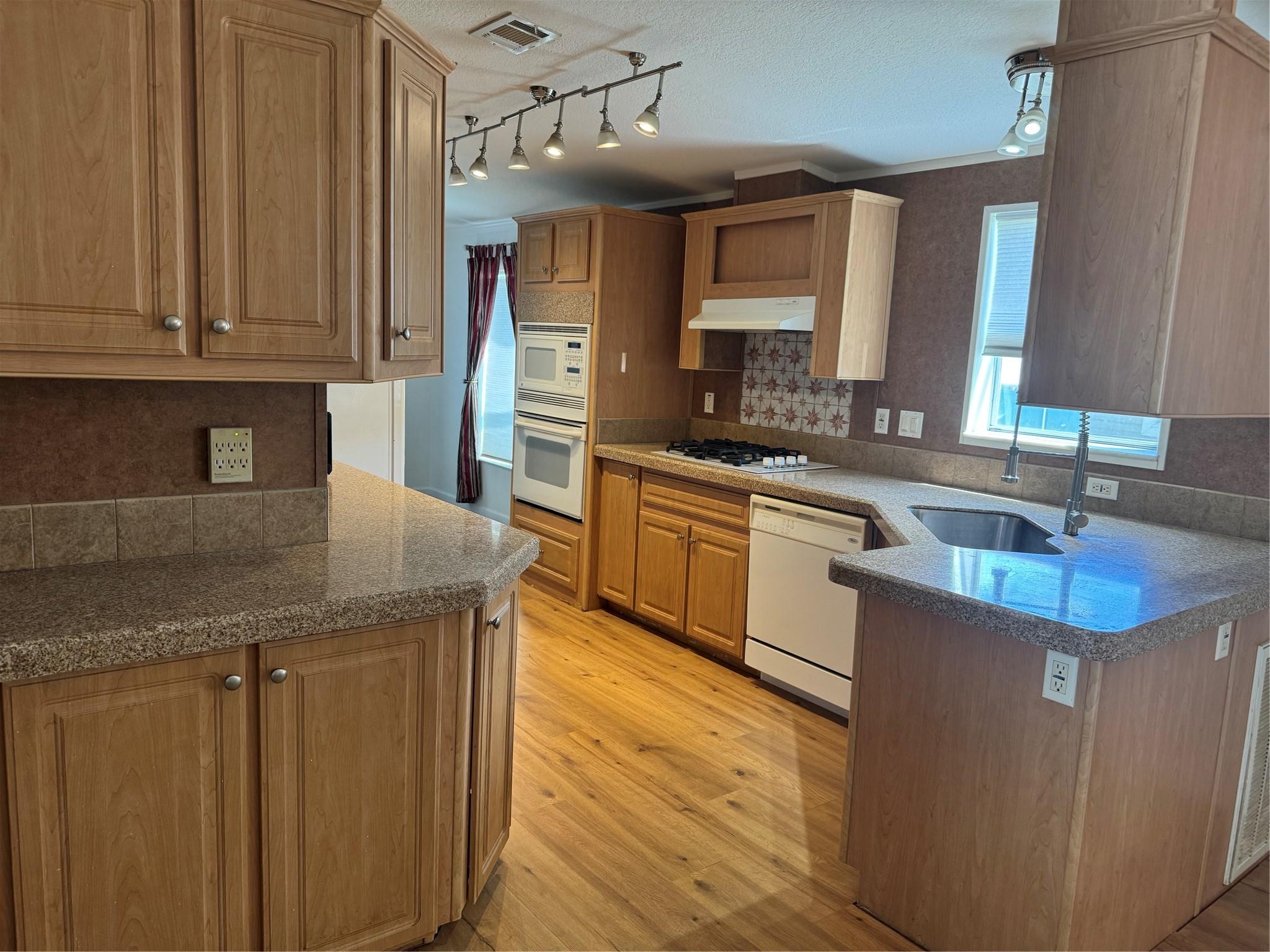 Land is included with this lovingly cared for 3 bed 2 bath newer 2008 Manufactured home. Open concept living, boasting all new wood flooring, quartz counters in kitchen and both baths, gas stove cooking, tankless water heater, central air conditioning, crown molding, and Laundry room. Large yard cared for by community, huge shed or workshop for the hobbyist. Fence enclosed for kids and pets to run and play. The community offers, Pools,Tennis courts, Play ground area, Basketball court, beautiful lake to stroll around, and a clubhouse. This community has a true sense of caring and helping thy neighbors. Close to amenities and entertainment venues. Don't miss the chance to own your piece of the dream.