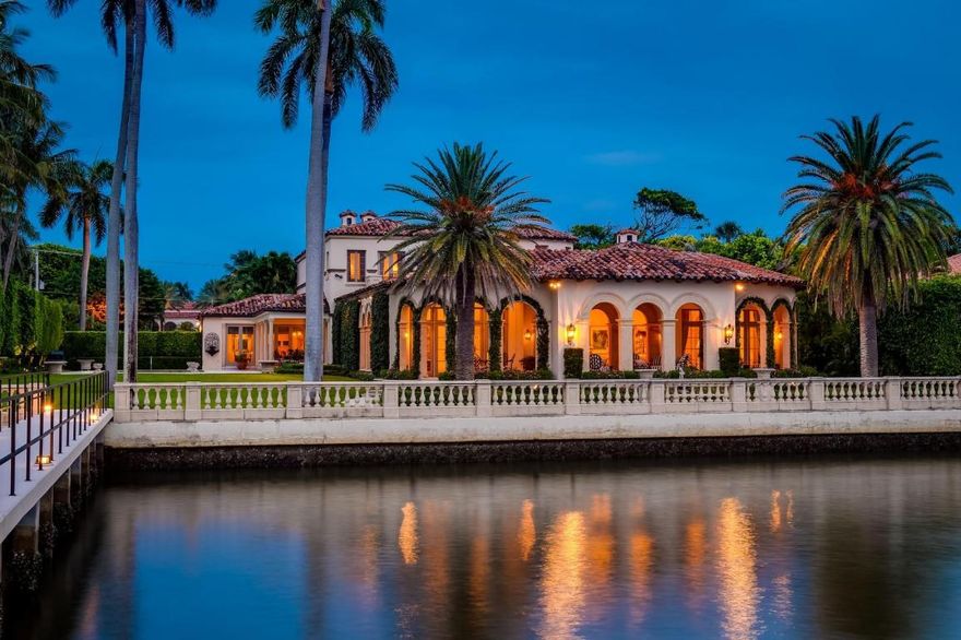 Spectacular Maurice Fatio designed Mediterranean Estate on the Intracoastal with gorgeous architectural detailing. With 17,000+/- total sq. ft. and 7BR/9.4BA, this stunning estate is perfect for entertaining. Elegant foyer with wrought iron spiral staircase leads to oversized reception room with 20+ ft. ceilings. Elaborate columned dining room seating 30, features beautiful fireplace and stunning coffered ceiling. Highlights include 60 ft. +/- formal living room, soaring ceilings, striking plaster moldings, gorgeous library, gym, and breakfast room with built-in grill. Formal loggia frames romantic sunsets overlooking the water. Gated entryway opens to beautiful carriage house, welcoming motorcourt, and 4 car garage. Meticulously manicured grounds features pool, beautiful fountains, dock, and 145 ft. +/- of direct Intracoastal frontage. Fantastic location in Palm Beach's renowned Estate Section, less than a mile to Worth Avenue's shops and restaurants.