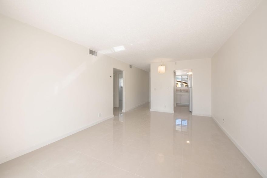 FULLY RENOVATED second floor corner unit 2bed/1bath with washer and dryer INSIDE the unit. A/C and Water heater 09/2024, Stove and Microwave 11/2025. Washer and Dryer 2023. Gorgeous porcelain title throughout the unit. The patio space was enclosed to create an oversized living room. 2 generously sized bedrooms. 1 assigned parking space in front of the unit and plenty of extra parking available on the street. Community pool. On-site management office. Dogs are welcome, no aggressive breeds. Close to the beaches, stores & restaurants, some just a short walk away. THIS IS A MUST SEE!