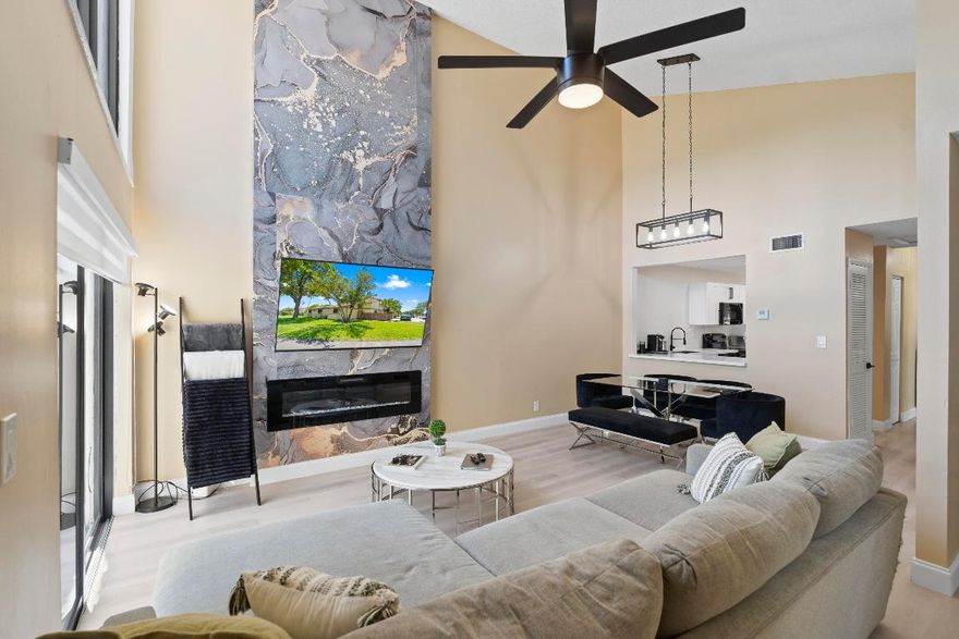 Come see this beautifully renovated, move-in ready, 3-bedroom, 2-bathroom corner townhome! This modern home offers an open floor plan, vaulted ceilings in the great room, and large windows with sliding glass doors that flood the space with natural light. Custom zebra blinds have been thoughtfully installed on the windows. 

The fully updated kitchen features wraparound quartz countertops, soft-close white cabinetry, subway tile backsplash, and a deep 10-inch black stainless steel sink with air-push disposal. The home boasts stylish waterproof grey-toned laminate flooring, updated lighting, remodeled bathrooms, and a cozy electric fireplace for added ambiance. Enjoy peace of mind with brand-new roof, newer water heater, impact windows and doors, and a full-size washer and dryer. Step outside to your private fenced-in porch or take in the peaceful, quiet lake view from the open patio. Additional conveniences include assigned parking, plenty of storage throughout, and ample guest parking. This pet-friendly community includes water, sewer, a basketball court, and a sparkling pool. Ideally located near top-rated restaurants, beautiful beaches, and the expansive Sawgrass Mills Mall. Welcome home!