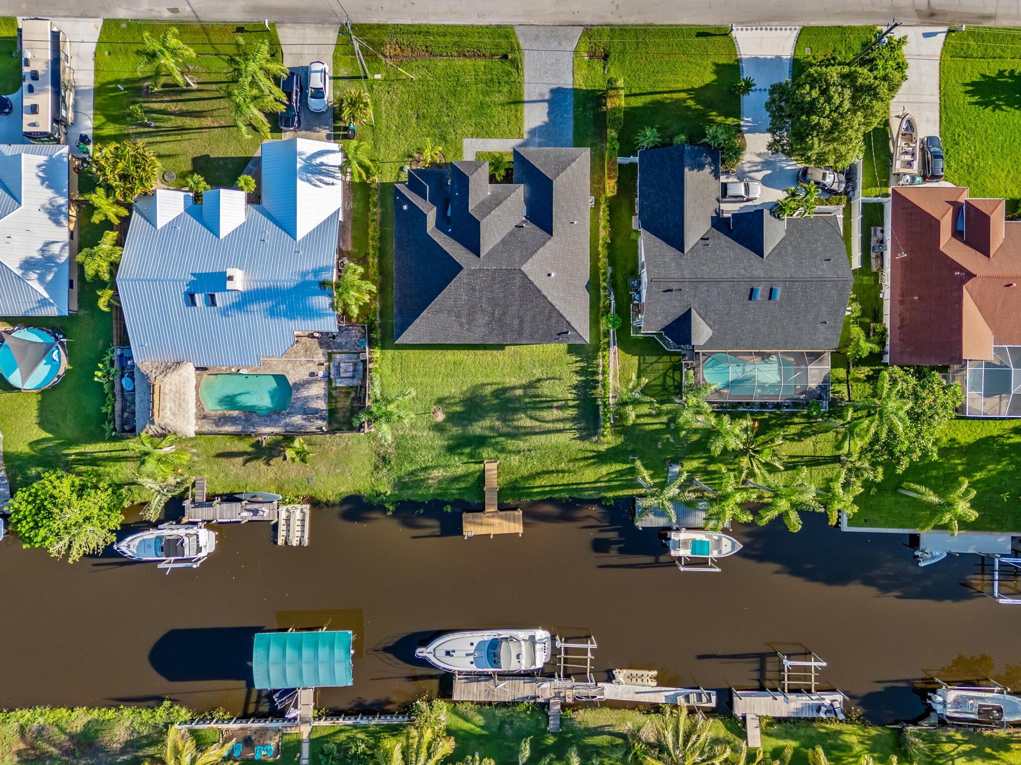 Welcome to 632 SE Seahouse Drive, where everyday living meets a waterfront escape. This NEW CONSTRUCTION 4-bedroom, 3-bath home offers over 2,400 square feet of thoughtfully designed space, including a bright open kitchen, formal dining, and a spacious great room perfect for gathering with family and friends. The primary suite is a true retreat, while the split-bedroom layout gives everyone their own space and comfort. Step outside to your covered patio and take in the view--your private dock sits just beyond, with direct ocean-access waterways ready for boating, kayaking, or simply soaking in the peaceful Florida lifestyle.