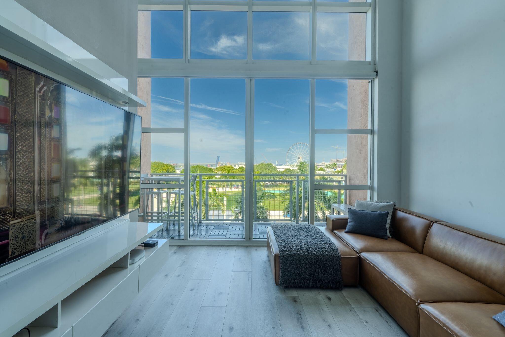 Located in the heart of Downtown Miami, this stylish 2-story loft offers nearly 1,000 SQFT of open living space, soaring 20-ft hurricane-impact windows, and a private balcony with city and bay views. Thoughtfully designed with built-in modern furniture and custom closets, it's fully turnkey and move-in ready. The open lower level includes a sleek kitchen, living space, and powder room, while the upstairs suite features a full bath and walk-in closet. In-unit washer/dryer included.Residents enjoy one of Miami's largest resort-style pool decks (currently being remodeled), plus a spa, fitness center, cold plunge, steam room, sauna, jacuzzi, theater, business lounge, and 24/7 concierge and security.