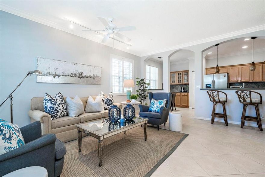 This beautiful townhome in the club community of Evergrene is situated with expansive lake views and a one-of-a kind extended front lanai. The impeccably maintained interior features a spacious great-room including a stunning built-in entertainment center. The updated kitchen includes stainless appliances, a breakfast bar and separate dining area. 1st floor master bedroom suite offers a large walk-in closet & spacious bathroom. Tasteful finishes include plantation shutter window treatments, custom closets, updated lighting, paint & flooring. Newer A/C, Nest thermostats and easy accordion hurricane shutters. The 2nd bedroom is roomy enough to be a "2nd master" with a large wall-to-wall closet and adjacent full bathroom with a combo shower and soaking tub. The 3rd bedroom also offers lots of closet space & natural light. The loft features a built-in office with tons of extra storage. The gated community of Evergrene is zoned in an A rated school district & features a resort style clubhouse overlooking a 36 acre lake & pier. Amenities include an infinity edge pool, spa jacuzzi, splash park, fitness center, full service Tiki bar, playground, putting green & beach. The fantastic location in Palm Beach Gardens is minutes to the beach, The Gardens Mall and world-class golf.