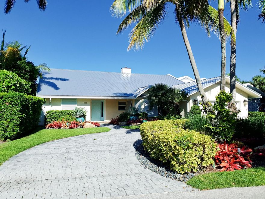 MORE PHOTOS COMING. Tropical water-front paradise located on the coveted north end of Hypoluxo Island. Don't be fooled by the low key entrance to this terrific home with 4,373 sq. ft. under air.  4 BR all with walk-in closets including a 2nd floor private guest suite, 4.5 baths. Walk to the beach, grocery, restaurants, and the 5-Star Eau Palm Beach Hotel. 2-car garage, open floor plan, massive grand living room with vaulted ceilings, hurricane impact windows and doors. Huge kitchen with center island, walk-in pantry, and breakfast nook. Spectacular back yard with lush landscaping, covered patio for outdoor entertaining, and separate outdoor kitchen. Plus your own private dock with intra-coastal access all the way to the Atlantic Ocean. Available for immediate occupancy.