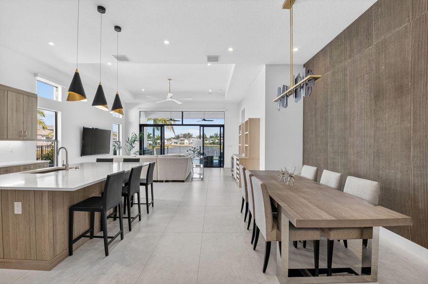Built in 2024 and located in the prestigious Lotus Palm community of Boca Raton, this exceptional residence offers refined modern living with over $300K in high-end upgrades throughout. Upgraded cabinetry, a chimney-style hood vented to the exterior, premium GE appliances, including a 36'' gas cooktop, built-in ovens, and above- and under-cabinet lighting. A custom buffet and dry bar with wine refrigerator adds an additional layer of sophistication for hosting. Full Lutron automation, providing seamless control of lighting, shades, climate, garage doors, and integrated Sonos sound, pool and spa controlled with iAquaLink smart technology, upgraded paved driveway, Reverse Osmosis Water Treatment, and more.