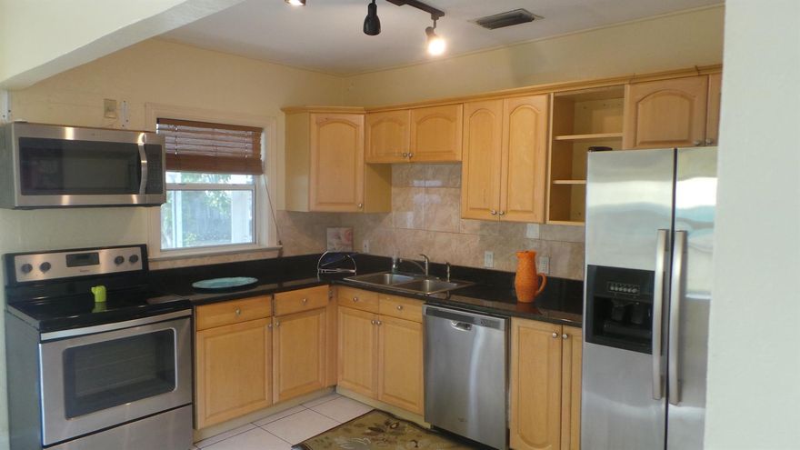 Investors Welcome, tenant in place at $2350''Welcome to this stunning Key West-style home nestled in the desirable South End neighborhood. With its original hardwood and tile flooring, woven bamboo blinds in the living area and bedrooms, and a beautifully remodeled bathroom, this property exudes warmth and character. Relax on the screened patio, surrounded by lush greenery and a bountiful fruit garden, or unwind in the fenced backyard with a serene garden view.Recent updates include a new roof (2006), plumbing (2016), appliances, and A/C (2020), ensuring a worry-free living experience.Located on South Dixie Highway, one of West Palm Beach's hottest thoroughfares, you're just steps away from:Dixie Dining Corridor, featuring renowned restaurants like Table 26,