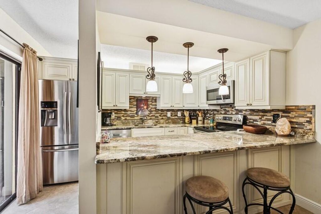 Photo of 7 Atrium Circle #D, Atlantis, FL 33462 (MLS # R11098885)