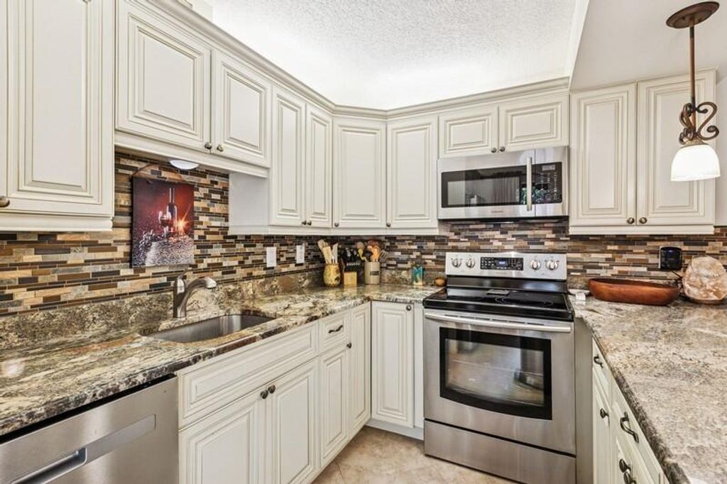 Photo of 7 Atrium Circle #D, Atlantis, FL 33462 (MLS # R11098885)