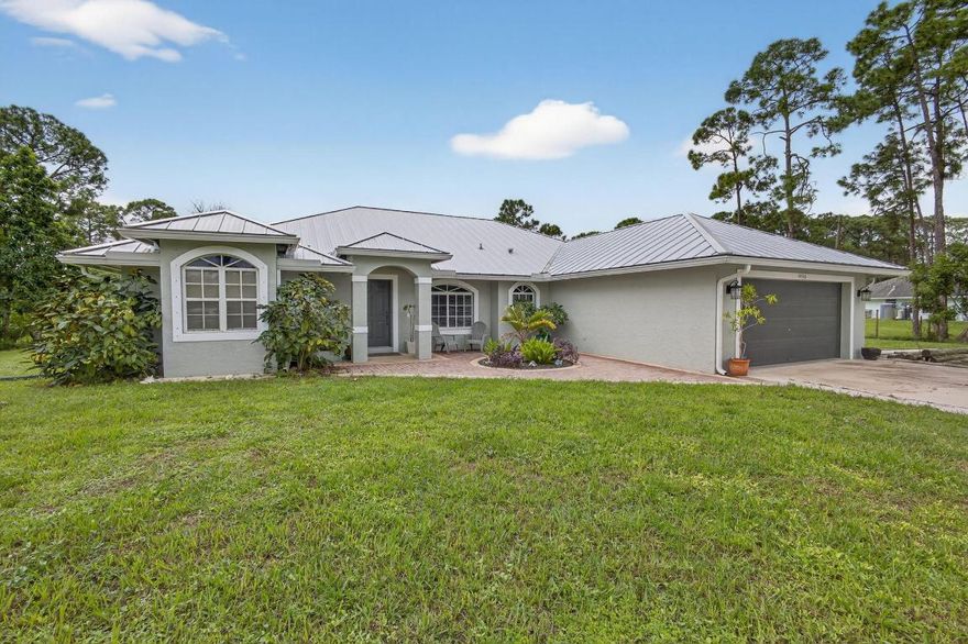 Location, Location, Location.  Beautiful CBS home on 1.15 acre lot with open floorplan, new metal roof & gutters (2022), new water softener and well pump (2023), new patio screening (2024), new vinyl flooring (2022), new smart Q garage opener (2024), Guest Bathroom remodel (2024), generator hook up, peach, mango avocado fruit trees, new kitchen Whirlpool stainless steel appliances and NO HOA.  Great family home with a large fenced yard for pets and plenty of room for pool and maintaining RV, Boat or large vehicles.  Peaceful neighborhood in growing Loxahatchee community nestled between two new up-and-coming Town Centers of Avenir and Westlake.  Don't miss this opportunity.