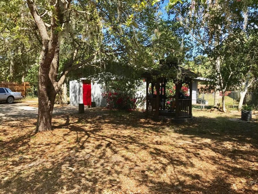 Cute CBS home in Lovely Country-like Setting in White City. Big and Beautiful Oversized Lot, mostly Privacy Fenced with Mature Oaks and Mango Tree. Adorable Exterior Gazebo for enjoying the sounds of nature all around you or sipping tea and watching the world go by. Location, Location, Location, Desirable and Quiet Street in White City is close to Beaches, Fishing, Shopping and EVERYTHING!