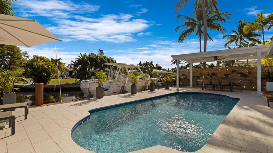 Experience elevated waterfront living in this beautifully updated home offering 70 feet of prime water-frontage and wide water views designed to impress from the moment you arrive. Fully protected with IMPACT WINDOWS & DOORS, and an impact-rated garage door, this residence delivers both peace of mind and refined coastal style.

Inside, the home has been thoughtfully updated throughout with a clean, modern aesthetic and a functional split floor plan that offers privacy and flexibility for everyday living. Natural light flows through the living spaces, drawing your eye toward the water and creating a seamless connection between indoor comfort and outdoor beauty.

The home is perfectly suited for boating enthusiasts, featuring a 10,000-pound boat lift and easy navigation with only one fixed bridge. Enjoy quick access to the Intracoastal in less than 15 minutes, making spontaneous boating days effortless.

Outdoors, the backyard is a true showpiece. The heated saltwater pool is equipped with new equipment and set against incredible water views, creating an ideal setting for relaxing afternoons or entertaining under the Florida sun. The expansive waterfront setting enhances both the lifestyle and long-term appeal of the property.

Additional highlights include a whole-home generator for uninterrupted comfort and reliability, further reinforcing the home's value and readiness for coastal living.

This is a rare opportunity to own a recently updated, move-in-ready waterfront home that blends modern upgrades, boating convenience, and unforgettable views. More details coming soon.