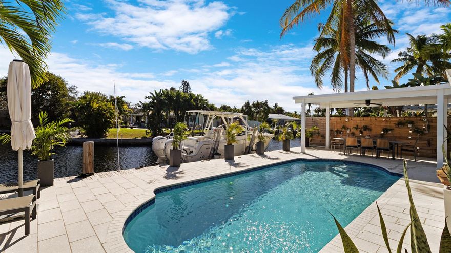 COMING SOON! Experience elevated waterfront living in this beautifully updated home offering 70 feet of prime water-frontage and wide water views designed to impress from the moment you arrive. Fully protected with IMPACT WINDOWS & DOORS, and an impact-rated garage door, this residence delivers both peace of mind and refined coastal style.Inside, the home has been thoughtfully updated throughout with a clean, modern aesthetic and a functional split floor plan that offers privacy and flexibility for everyday living. Natural light flows through the living spaces, drawing your eye toward the water and creating a seamless connection between indoor comfort and outdoor beauty.The home is perfectly suited for boating enthusiasts, featuring a 10,000-pound boat lift and easy