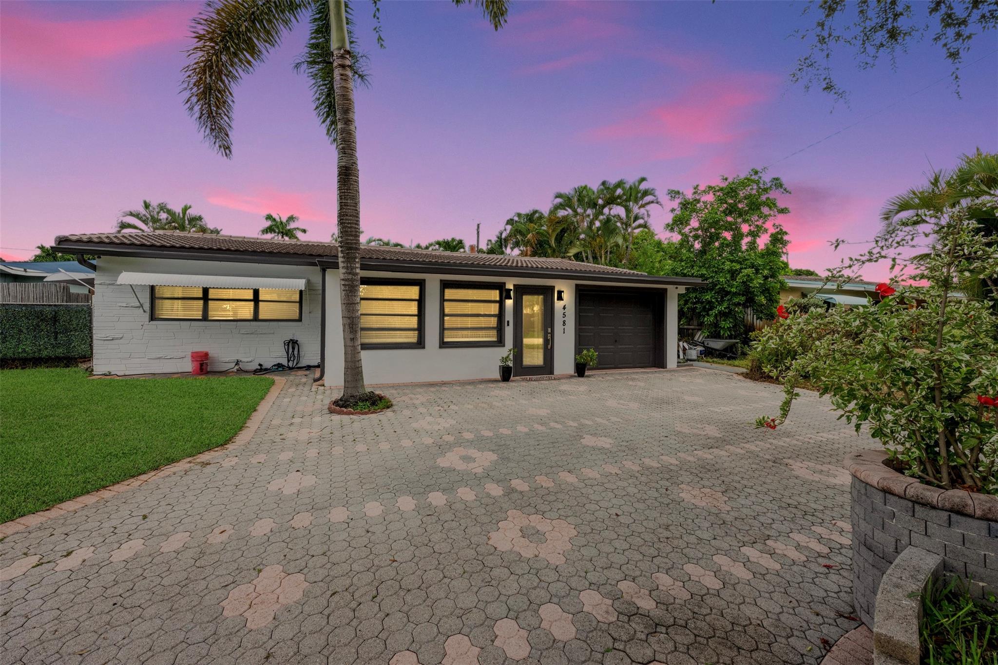 Step into your own tropical retreat in the heart of Oakland Park. This charming 3BD/2BA pool home welcomes you with sun-filled rooms, fresh paint, and sleek LVP flooring throughout. The spacious kitchen offers granite countertops, stainless steel appliances, and custom cabinetry, perfect for cooking and gathering with loved ones. The serene primary suite features a beautifully upgraded bath with a new vanity and designer tile. With a newer roof, natural gas lines, and a stand-alone generator, comfort and peace of mind are built in. Outside, relax by the sparkling pool, surrounded by lush gardens, swaying palms, and a gazebo made for entertaining or peaceful evenings. Just minutes from Wilton Manors, local cafes, parks, and the beach.