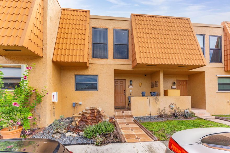 This property has an assumable mortgage. This exquisitely remodeled lakefront townhome features an updated kitchen with granite counters and stainless steel appliances. Every corner of this home is graced with designer touches that create an ambiance of sophistication and elegance, including designer lighting, crown moldings, updated tile flooring, and remote-control shades. Additional upgrades include a tankless water heater, impact windows and doors, and a three-year-old central air conditioning system. The second level boasts a master suite with a spacious walk-in closet, along with two additional bedrooms and one bathroom. Enjoy serene moments on the screened patio or take advantage of the community's multiple pools, clubhouse, fitness room, and tennis courts. Maintenance includes C/I.
