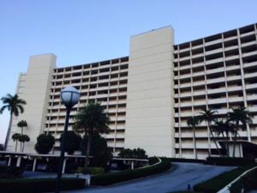 Greet the gorgeous sunrise from your balcony in this updated unit facing Lake Worth.  Upgrades include newer cabinetry with KitchenAid appliances, porcelain tile flooring and berber carpeting, custom built-in entertainment unit with wide-screen TV, solar shades in LR and DR, plantation shutters in both bedrooms, California closets, in-unit Bosch washer and dryer, new water heater and 2-ton AC unit.