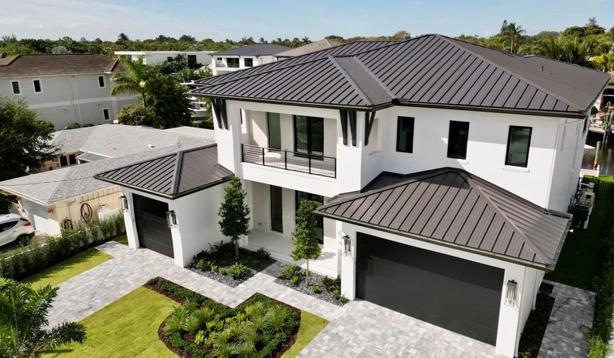 Prepare to be captivated by this brand new custom estate, a true masterpiece set on a rare, oversized canal lot in the heart of P B Gardens.  Designed for the discerning buyer, this home offers direct ocean access with no fixed bridges, allowing for seamless navigation. No expense was spared in its construction, featuring the finest finishes and impeccable attention to detail throughout.  The residence provides a gracious and adaptable layout, highlighted by five generous bedrooms, each with a private ensuite bath, for a total of six full and two half-baths. Convenience is paramount, with a desirable primary suite located on the first floor and a private elevator. Completing this exceptional offering is a three car garage and an ideal location minutes from the finest dining and shopping! Built-in closet cabinets in all closets.  Hidden pantry.  Hidden storage under the stairs.  Wine room with wine cooler.
500 gallon propane tank supplies the fireplace, cook top, summer kitchen grill, 3 tankless water heaters, 2 fire bowls by the pool and plumbed for future generator.
The canal is wider than most at +/-84'.  It leads to a lagoon and then no fixed bridges to Palm Beach or Jupiter Inlets.