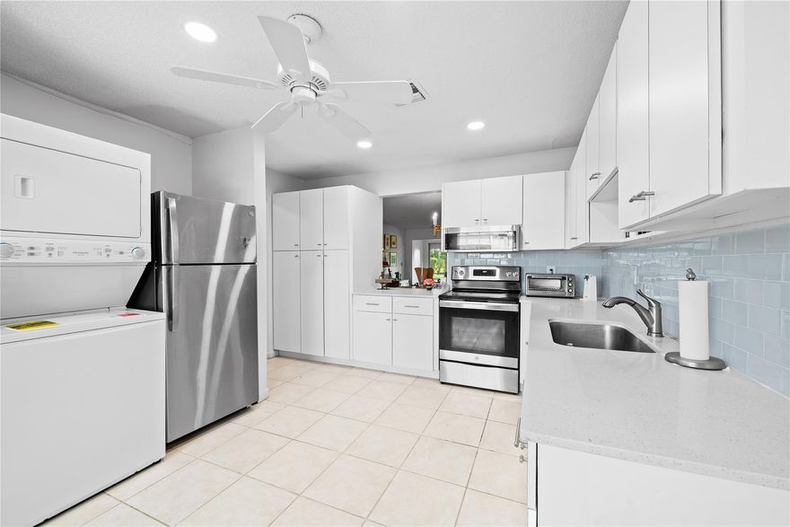 Enjoy over 1,500 sq. ft. of spacious living in this first floor condo—including a screened-in patio—in this beautifully renovated waterfront condo located in a quiet, park-like setting on the canal. This condo offers extra room to entertain in the huge great room and large eat-in kitchen w/open pass-through and scenic green views visible throughout the unit. The ensuite primary bedroom features dual vanities, two sinks, and two walk-in closets. Step outside and enjoy plenty of outdoor space to BBQ, fish, or simply relax in your private oasis. Other highlights include full accordion hurricane shutters, dedicated parking, and cable TV included. Pines of Delray North is a 55+ man-gated community w/an onsite manager, two pools, gym, clubhouse, and a variety of athletic and social activities.