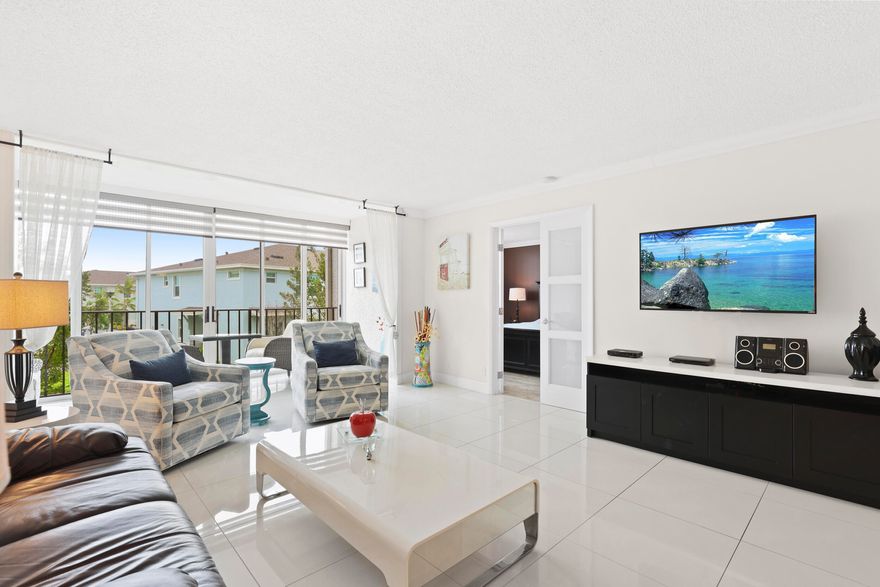 Move-in ready, updated 2-bedroom, 2-bath condo with in-unit laundry. This very well maintained unit is easily one of the nicest and best-priced units in the building. It is located on the 2nd floor with elevator access in the ALL-AGES Trevi section of the highly sought-after Fountains Country Club, a 24-hour gated community with NO MANDATORY membership. It features *a split-bedroom floor plan, *NO carpet, *large-format tile and neutral laminate flooring. Upgrades include *plantation shutters on every window, *beautiful frosted glass interior doors for a modern feel, *a 2021 A/C system, *a new electrical panel (2026), and *a 2022 roof. Enjoy extra living space in the enclosed screened patio—perfect as a relaxing sitting area.  Ample storage includes walk-in closets in both bedrooms, a kitchen pantry, linen closet, and a private 4x4 exterior storage unit. You are just steps from the large subdivision pool, or you can enjoy the resort-style pool at the main club. HOA covers water, cable & wifi, roof maintenance and more.  With a 2022 roof and a completed Milestone and Reserve Study, this condo offers peace of mind in a prime location. No mandatory membership required, optional membership packages available. Conveniently located near major highways including I-95 and the Florida Turnpike, as well as shopping, dining, whole food etc.  All info and dimensions are to be verified by buyers.   Furnished included or can be removed.