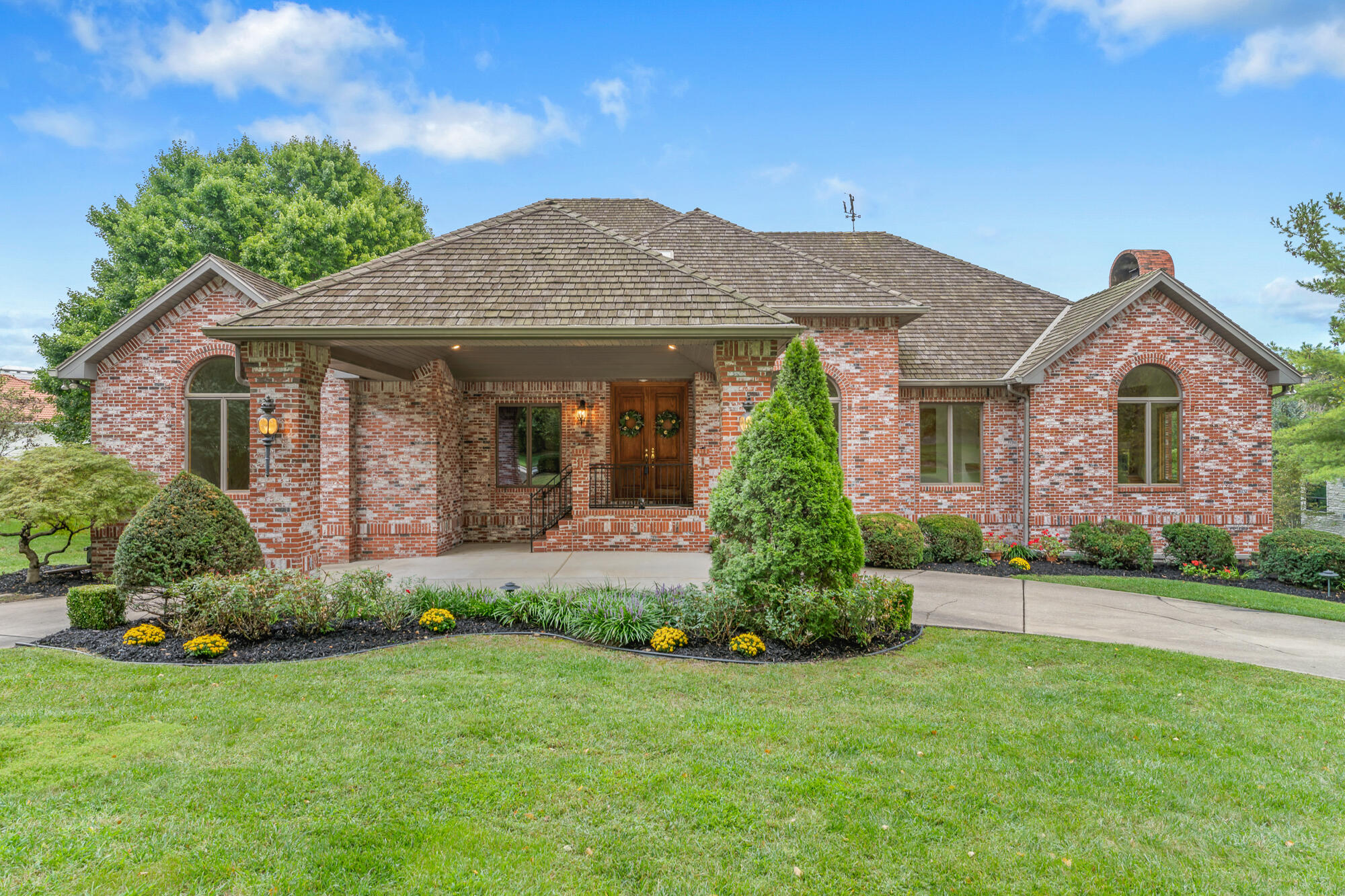 This one owner custom home has been refreshed with new paint and enhanced landscaping.   The home is located in the only gated neighborhood with 24 hour security in the beautiful Highland Springs Golf Community.  The lovely property includes not only a golf course view but a lake view too.  This premier level lot is approximately .89 ac.  The all brick home includes soaring ceilings, walls of windows to capture the views, and large spacious rooms for the family to enjoy.  Welcome your guests from the  generous foyer with white marble flooring enhanced by a skylight and crown molding.  It opens to a great room with a stunning white marble gas fireplace, generous formal dining room and a study with walls of bookcases. The kitchen includes a large granite island, solid surface counter tops, newer appliances,  a walk-in pantry and a breakfast area.  A 2nd living area with a gas fireplace and wet bar is convenient to  the kitchen as is the delightful sunroom with gorgeous views.  The awesome master suite is accessible to a large deck that goes across the entire back of the home.  The master bath has dual sinks, walk-in shower, whirlpool tub and walk-in closets.  A 2nd large bedroom and full bath is also on the main floor in addition to 2 guest baths.  The large laundry room with a soaking sink  and built-in ironing board completes the main floor.  The lower level has 2 large living areas divided by the 3rd gas fireplace, a wet bar, 2 more bedrooms and a  jac n jill bath.  Not to be overlooked is a large storage area, workshop, 3 car oversized garage, a covered drive thru and a fantastic backyard for family fun in a gated community.  This home and lot is not replaceable at this price!  It is ready for you to add your decorating preferences. The wonderful country club offers a great restaurant, meeting rooms,  tennis, pickleball, golf and swimming pool.  Make your families precious memories here!  Call to see today.