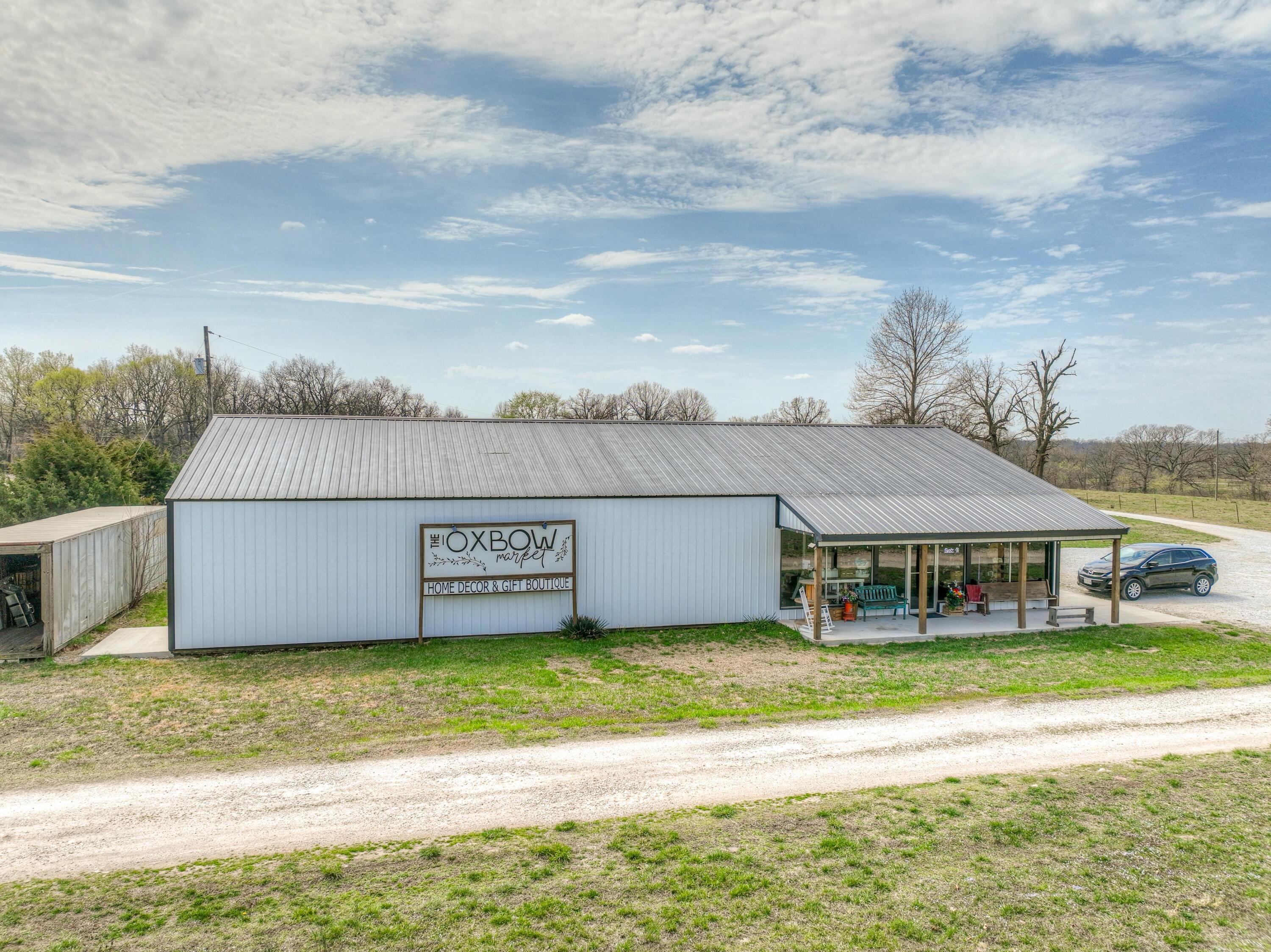 EXCELLENT, VISIBLE COMMERCIAL LOCATION BETWEEN NEOSHO & SENECA. Commerial building is 3350sqft, and currently used  as RETAIL SPACE.  Would easily convert to warehouse, storage, shop, and other commercial uses.  Invest some cash and turn this building into a duplex or barndominum. Comes with 2380sf house, barn/workshop and 8.85 acres.  Live in the house, work your business from the commercial building, and/or develop the acreage into other financial opportunities.  So many possibilities!  See listing for 8613 Oxbow for more details on the residence.