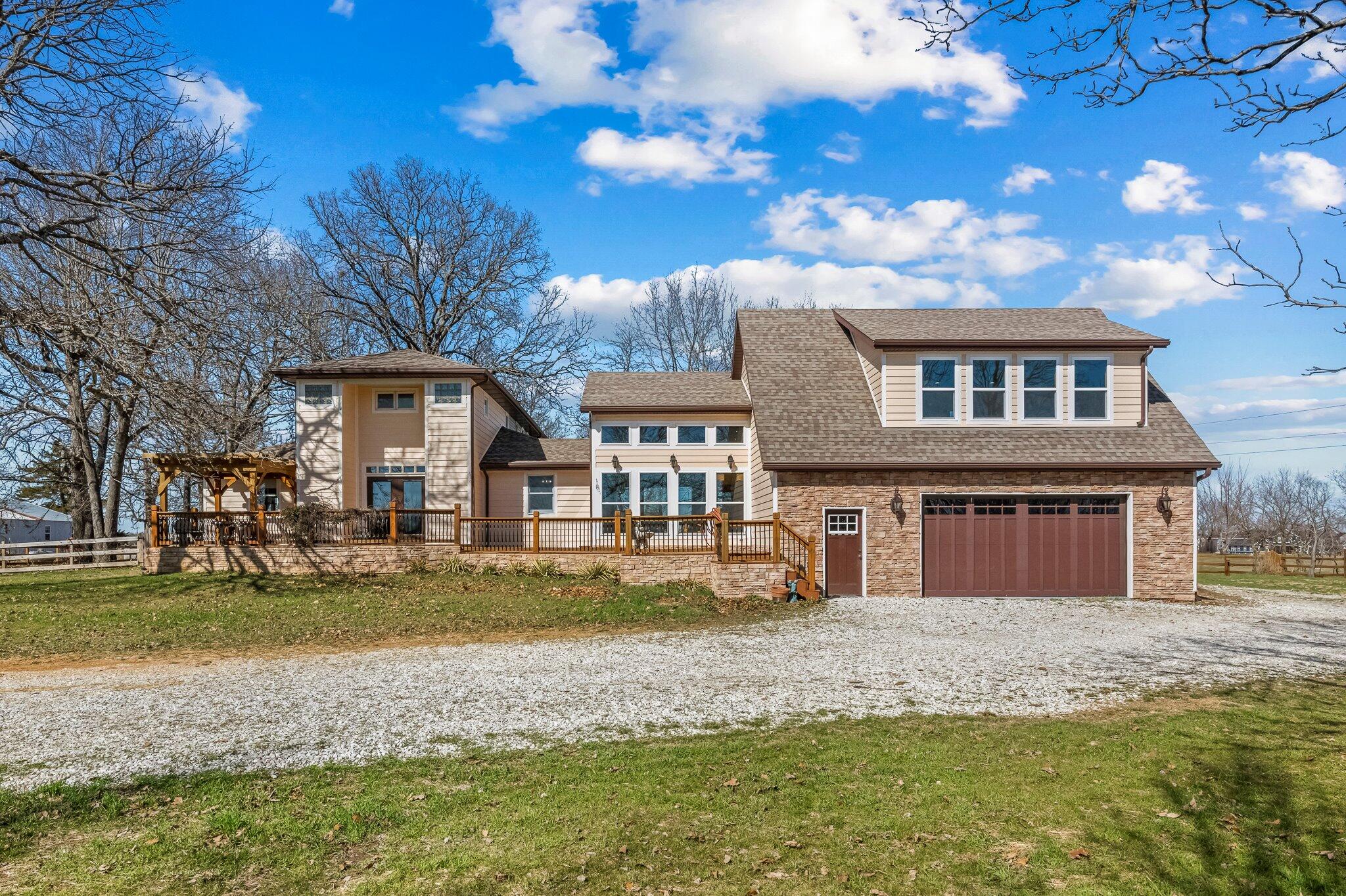 One of a kind property on 5.2 acres in Webster County! Large home with a gated entrance, an attached oversized garage and a finished outbuilding ready to be used as a boarding facility or kennel. The kennel building includes 14 complete indoor/outdoor runs, attached kitchenette and permanent power washer. Bring your horses too! The finished area above the garage adds some amazing square footage to this already spacious home. Beautiful features in the home including soaring ceilings, large windows and rustic finishes. Head downstairs to find two additional bedrooms, a relaxing full bath and plenty of storage space. Several additional outbuildings on the property and fencing make it ready for livestock. Nice pasture area and several different fenced enclosures. Make plans to see this property today!