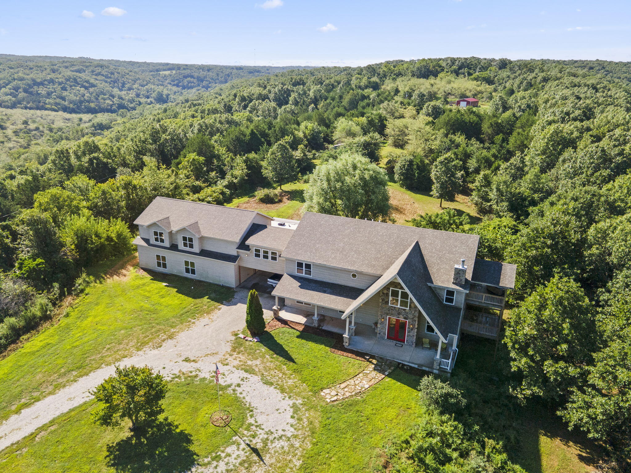 This stunning estate, surrounded by the Ozark Mountains, boasts breathtaking views from every angle!  Featuring 3+ living areas, 5 bedrooms, 3.5 bathrooms, walk-out basement, 4 stall garage, plus a 2-car carport, along with room for your camper or RV and all on 5 acres.  Over 8,200 sq ft under roof with approx. 5700 sq ft finished and 2500 sq ft partially finished.  A few of the many amenities include a gourmet kitchen, complete with custom cabinets, granite countertops, and a built-in wine rack, a sunroom featuring a potbellied stove, mother-in-law quarters, as well as the home being crafted with cutting-edge SIPs panels.  Located in SE Galena, with quick highway access, as well as close Table Rock Lake access! Reeds Spring or Galena Schools. Can acquire additional acreage for additional $$. Priced to Sell Fast.  Must See!  Won't Last.