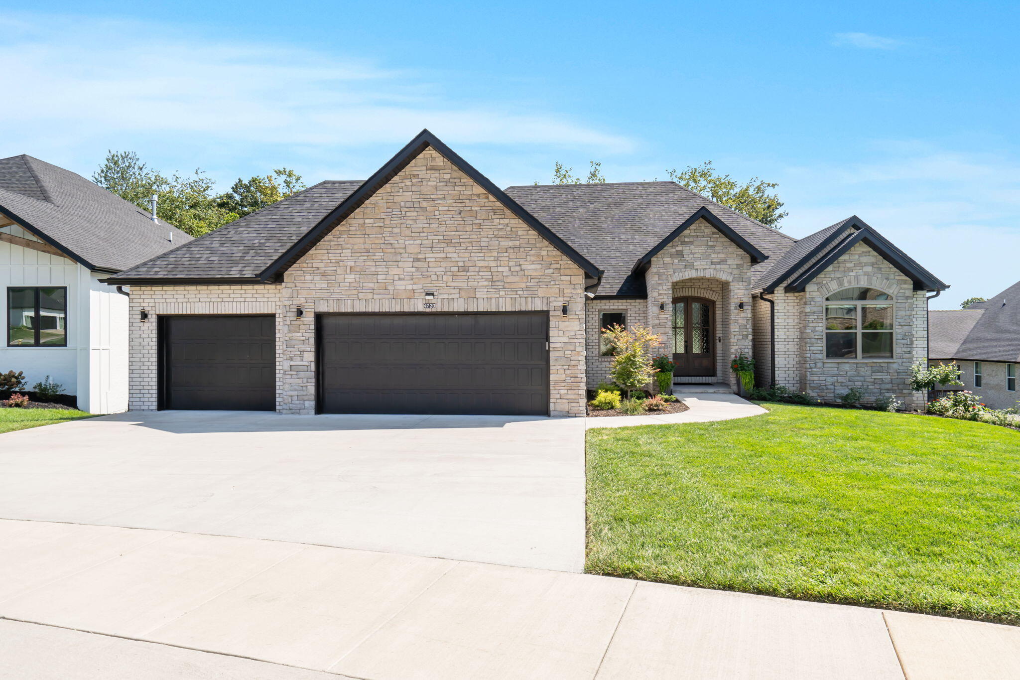 Like new all-brick and stone home in East Springfield, located in the gated community of Forest Trails. This stunning home showcases an open living design that effortlessly merges elegance with comfort, creating the perfect setting for both relaxing with the family or entertaining. As you enter through the double entry doors, you're greeted by an expansive living area, where vaulted ceilings and a striking stone gas fireplace create an atmosphere of grandeur.The gourmet kitchen is a culinary masterpiece, outfitted with immaculate white cabinetry, a Wolf gas cooktop, wall oven, generous island, and a spacious pantry, making it ideal for both everyday meals and lavish dinner parties.The main floor master suite serves as a private retreat, complete with a spa-inspired en suite that includes a tiled shower, luxurious soaker tub, private water closet, and dual vanities. Two additional bedrooms on this level share a beautifully designed second full bath with a tiled shower, providing comfort and style for family and guests alike. Additionally, a conveniently located half bath off the garage entry adds to the thoughtful layout.The walkout basement is massive with 10+ foot ceilings and room for a large second living area and all the games you can think of. There is even a full wet bar, two additional rooms for workout, or private office, and a storm shelter. Plus two more expansive bedrooms, one with custom built-in's, along with a third full bath finish out this amazing space.French doors open to a lower-level patio, seamlessly blending indoor and outdoor spaces, perfect for enjoying the natural beauty that surrounds you. Outside, you'll find a covered main floor deck, a charming fire pit area, and lush landscaping that backs up to a tranquil wooded area, offering a sense of seclusion.