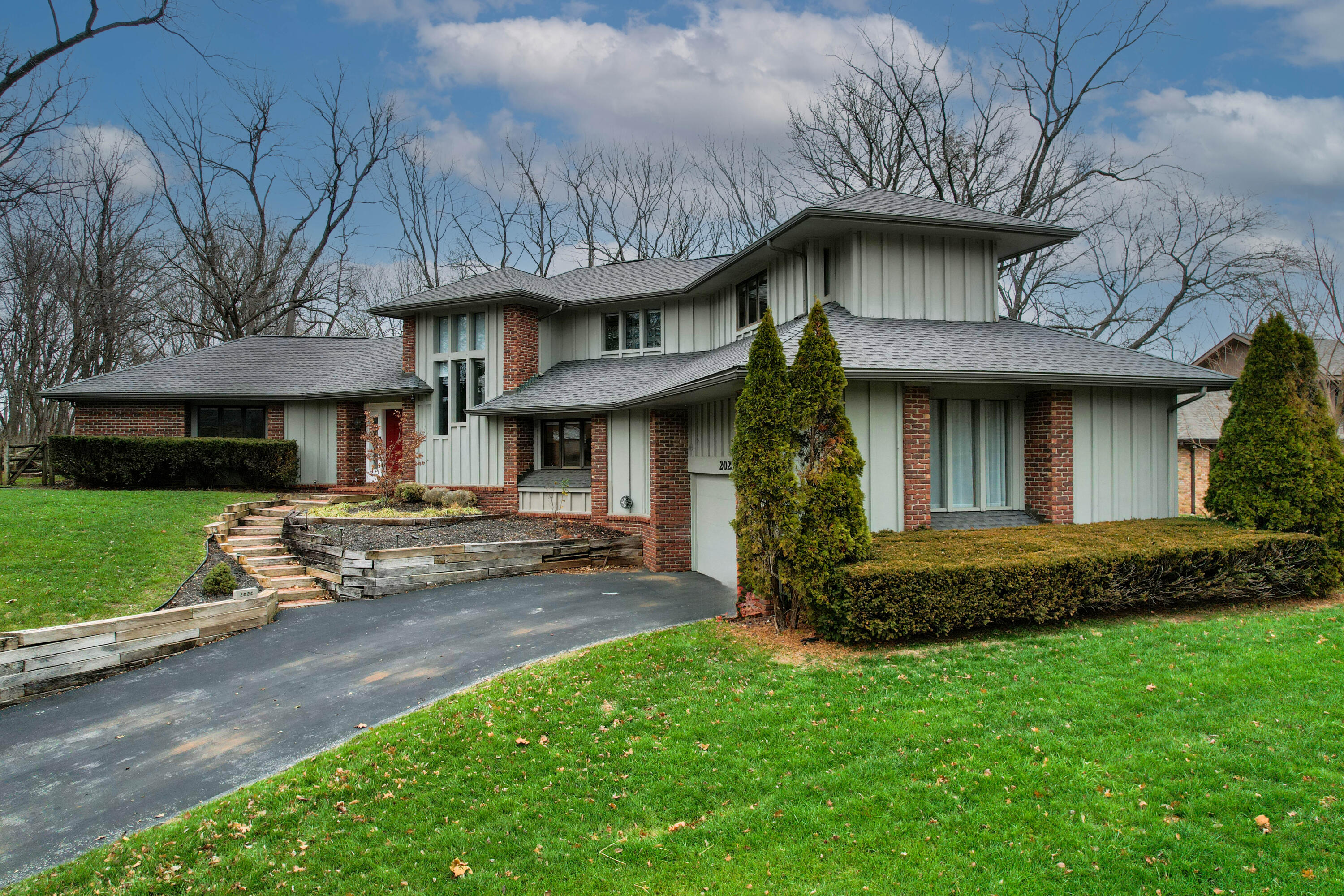 Here is a rare opportunity to buy a Frank Hill designed home from the second owners! They have carefully updated the home with modern finishes without sacrificing the original style and ambience.  Updates include new zoned heating and air, new windowpanes (modern double pane windows in the original frame and trim), quartz countertops, induction stovetop and modern smart home features. The roof was replaced in 2018.  Modern and rustic elements such as soaring ceilings and natural stone combine to create a warm, inviting space that feels modern and sophisticated, cozy and timeless. The front path, back patio and kitchen keeping room are made of genuine Fort Scott brick.  The stone fireplace heatilater is ducted to the primary bedroom and the keeping room off the kitchen.  The primary bedroom is on the main floor and includes an en-suite with a luxurious spa atmosphere and luxuries such as a heated floor.  Upstairs you will find a versatile living space, two Jack and Jill bedrooms with a full bath. At the end of a cul-de-sac, the location is quiet. The backyard has a classic split rail fence with pet proof smooth wire mesh.  Check back for floor plans!