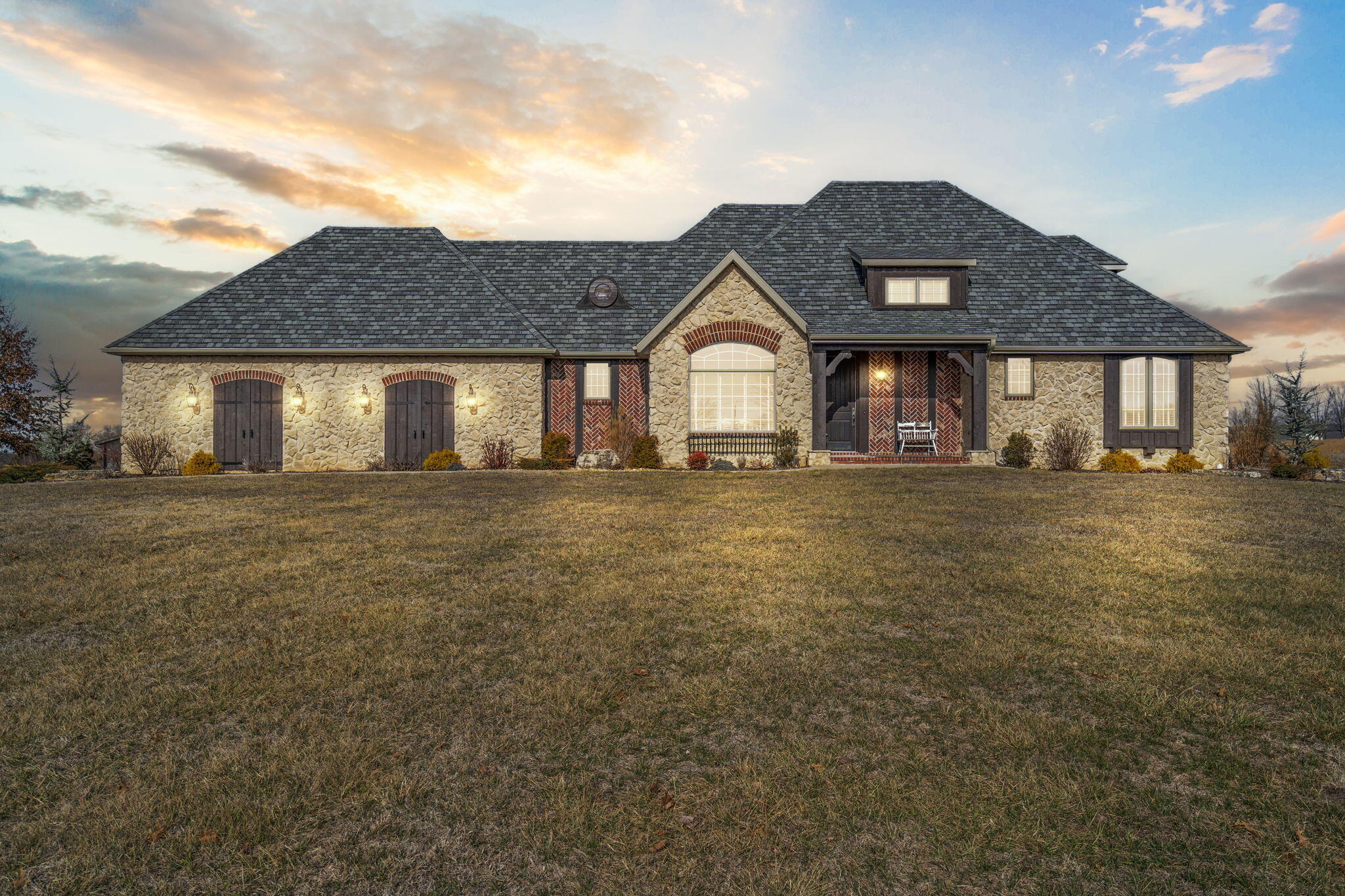 Welcome to 6572 South Farm Road 203 in Rogersville, Missouri! This stunning property is perfectly situated on 6 gorgeous acres complete with a paved driveway, inground saltwater pool (new in 2022) and a heated/cooled shop. This meticulously maintained home is just minutes away from Springfield and within Rogersville school district! Recently remodeled this beautiful 4,720 square foot, 4-bedroom, 3.5 bathroom residence, complete with a dedicated office and workout room is the perfect combination of luxury and functionality. The open kitchen is perfect for entertaining with plenty of counter space and is right off of the formal dining room and breakfast nook. The living area, with its cozy fireplace and built-in shelving is the perfect spot to relax after a long day and in the summer has the perfect view of the pool area. The spacious master suite boasts views of the entire property, and has a large master bathroom with double vanities, a water closet, jetted tub, and a large walk-in shower. Upstairs you will find two exceptionally large bedrooms with a Jack in Jill style bathroom, both with large walk-in closets and a separate room perfect for a sitting area, den, or study. Downstairs you will find a second kitchen area , workout room, office, large living area with built ins, and a large bedroom and bathroom. The downstairs area walks out to the magazine worthy pool area complete with a 32x16 inground salt water pool, beautiful stamped concrete, large rock retaining walls/stairs, and stunning landscaping/lighting. The property also includes a 38x24 heated/cooled shop with loafing shed/garden shed. This hard to find property is finally on the market and is move in ready! Come see what it's all about!