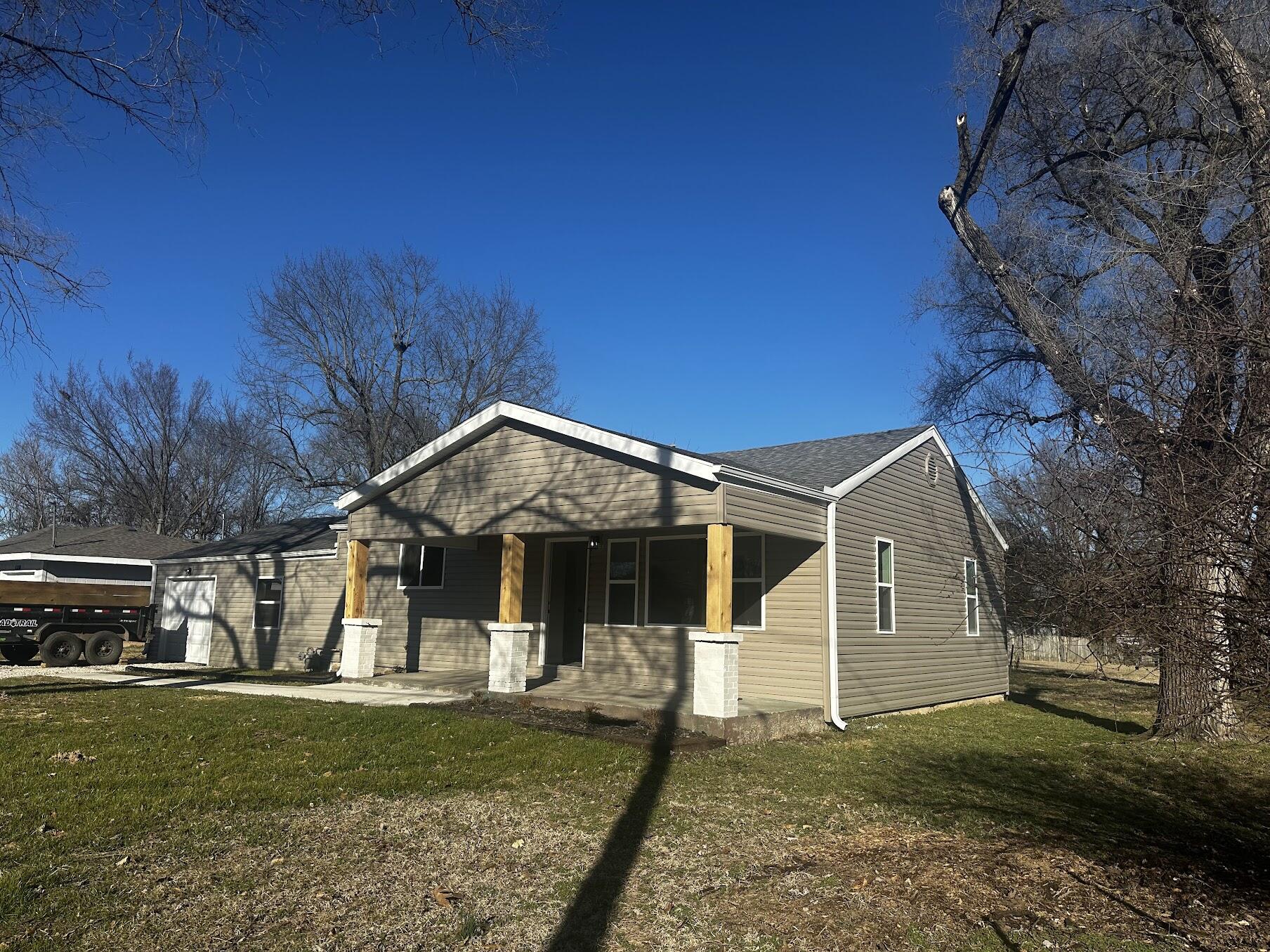 Here is an opportunity to buy nearly the equivalent to a brand new house, with 4 bed 2 bath and attached garage, at a significant discount. The absolutely thorough and professionally remodeled house was just completed. Not only is there an enormous flat yard big enough for a huge workshop or other uses in the back, and newer construction houses right across the street, but the house was torn completely down to the frame and foundation and rebuilt all new. Brand new updates include: Complete brand new electrical system from the service mast/panel/all circuits/all fixtures/outlets/switches, all supply and drain complete brand new  plumbing, 100% new exterior siding, vinyl double pane windows, roof, gutters, all drywall/mud/paint, all doors, trim, all flooring, Complete brand new kitchen cabinets and appliances, 2 completely brand new bathrooms with all fixtures, complete brand new HVAC. It is like moving into a new house in so many ways.