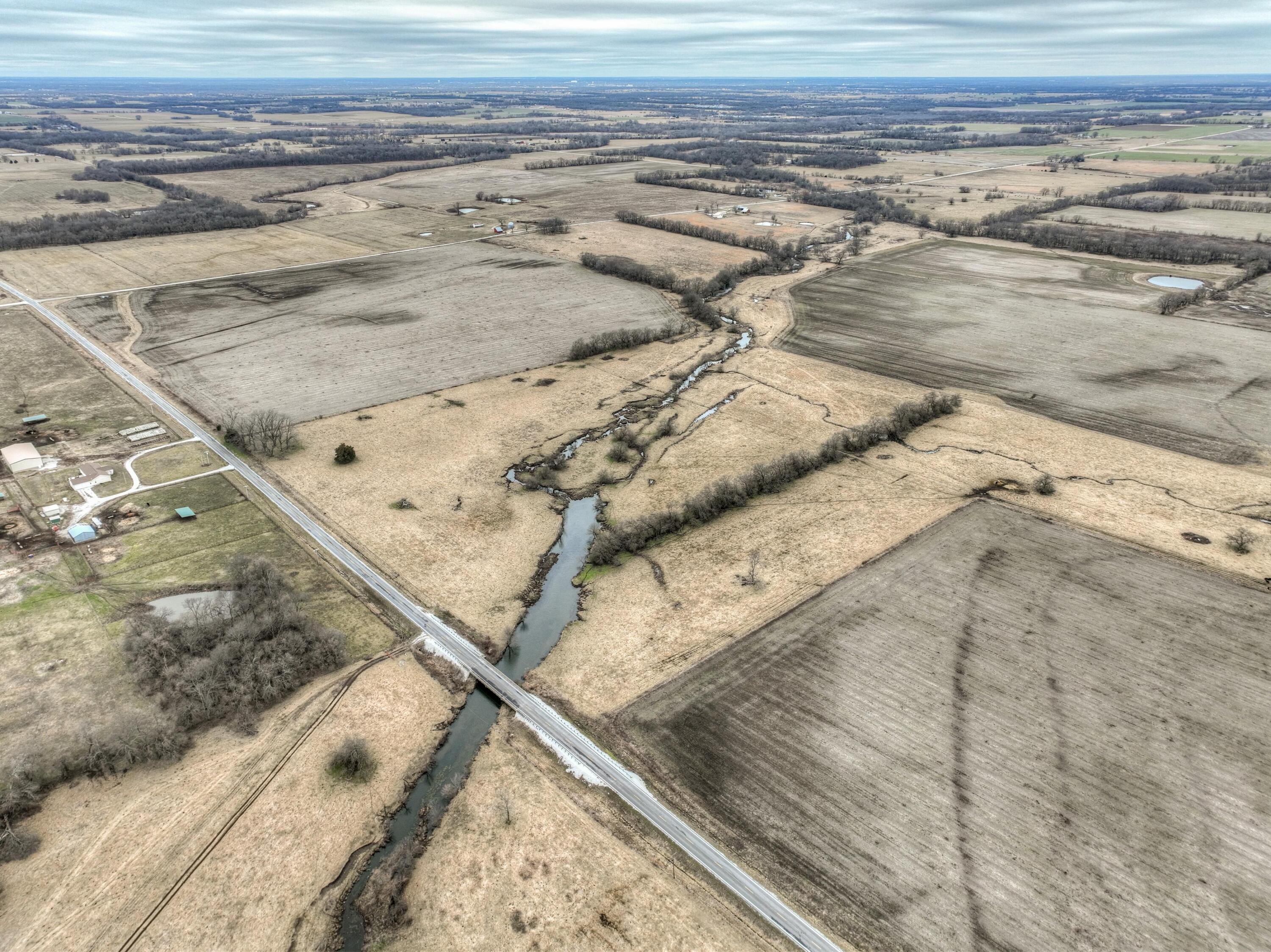 Discover a rare opportunity to own a slice of Missouri's heartland with this exceptional 160-acre farm in Eastern Jasper County. This prime farmland offers a unique blend of productive, tillable ground and lush pasture. The 160-acre tract is thoughtfully fenced and cross-fenced, boasting 97 acres of rich, tillable land ready for cultivation, along with over 60 acres of established pasture and a small, picturesque one-acre wooded area. A new survey will be provided by the sellers, clarifying the boundaries of this parcel, which currently comprises the South 160 acres of a larger 320-acre tract.  This remarkable property, with its combination of productive farmland and convenient amenities, is a must-see for discerning buyers! There is no turbine or solar lease on the property.