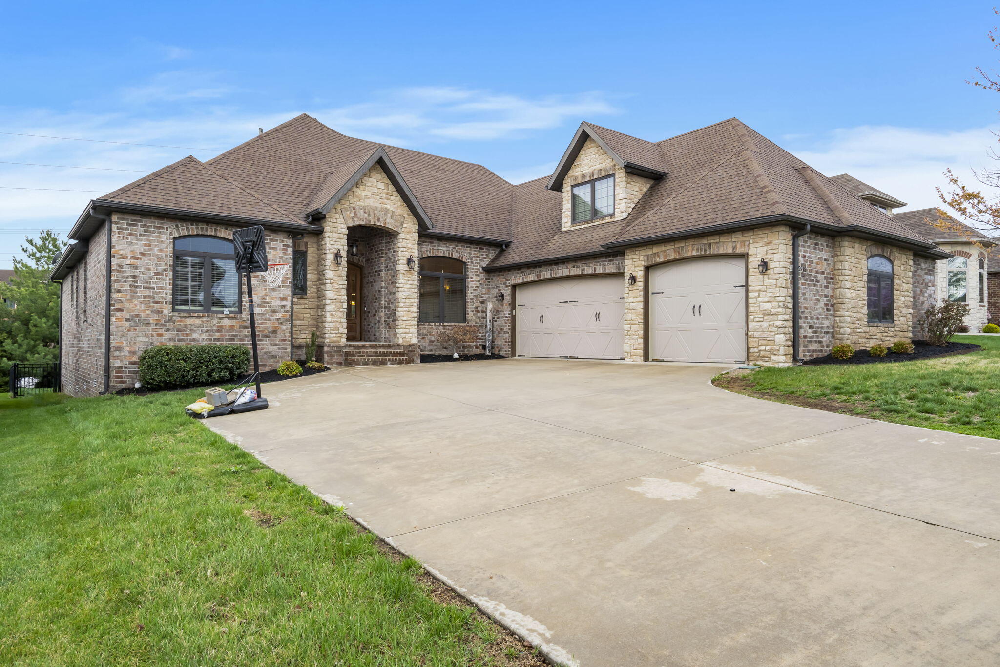 Stunning all brick home in Ruskin Heights! Featuring 5-bedrooms and 3.5-bathrooms with a spacious floor plan and modern features in a prime Springfield location. Enjoy a bright living room with gas fireplace, formal dining room with coffered ceiling, a well-equipped kitchen with granite counters, a central island, walk-in pantry, and generously sized bedrooms. The primary suite offers tray ceilings, a dual sink vanity, jetted tub, walk-in shower, and large walk-in closet. 2 bedrooms share a jack-and-jill bathroom and the 5th bedroom is located upstairs with a private en-suite bathroom. The backyard is perfect for outdoor activities with a stained concrete patio, covered deck, and included playhouse. Located just minutes from schools, Dan Kinney Family Center, shopping, dining, and major highways, this home offers easy access to everything Springfield has to offer.