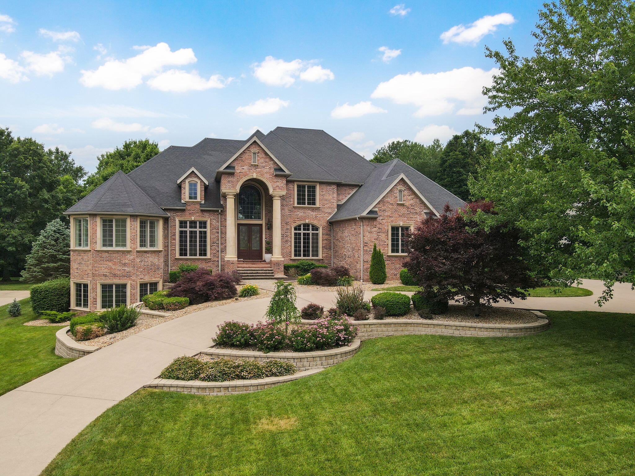Welcome to 3860 E Turtle Hatch Road! This beautiful home on over 3/4 of an acre is conveniently located in The Terraces, a gated subdivision close to everything. Walk into this home and be greeted by a dramatic living room featuring floor to ceiling windows and a stunning curved staircase. The formal dining room and a gorgeous office are situated close by. You will love the architectural ceilings in the hearth room and kitchen which also features two islands with granite, walk-in pantry and a surplus of cabinet storage. The master suite will not disappoint with its sitting area and lovely bath. There is a second stairway leading to an upstairs bonus/play room and 2 additional bedrooms, each with their own bath. The lower level offers a media room and wet bar, as well as two more bedrooms, exercise room and John Deere room. A spacious deck overlooks the large private lot lined with mature trees on the back side. Don't miss this spectacular home!