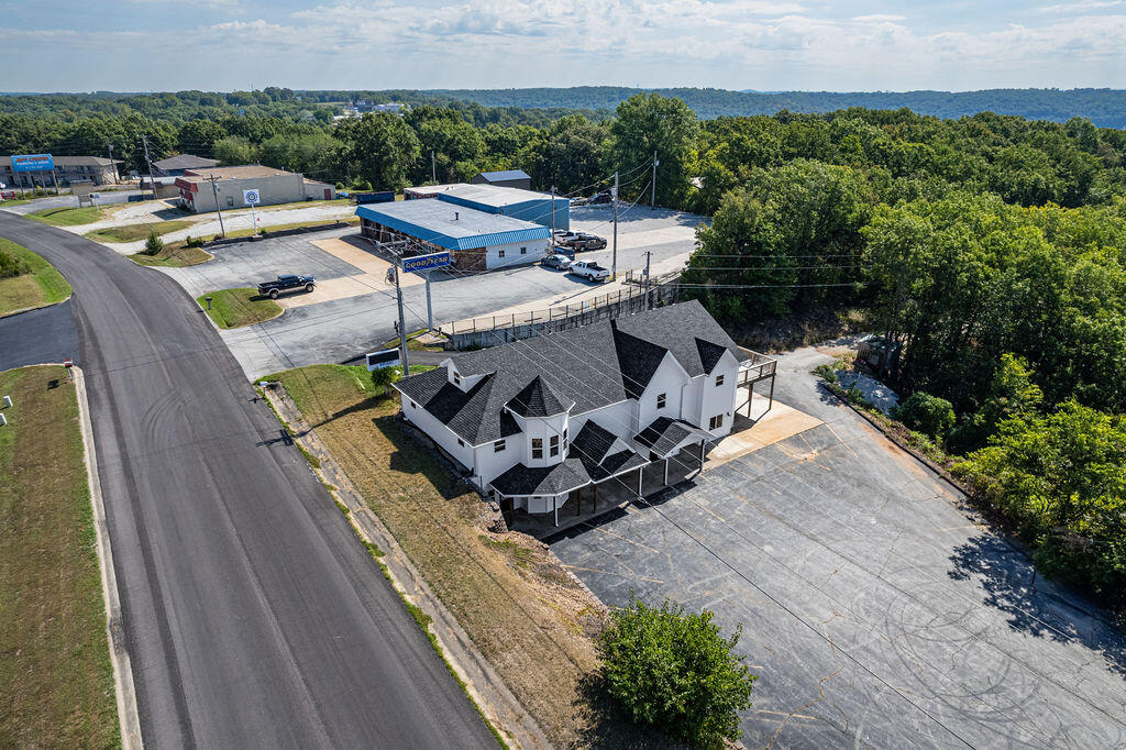 Prime Commercial and Residential Opportunity with Lake Views and Endless PotentialWelcome to 14788 Business 13, Branson West, MO a versatile, commercially zoned property that perfectly blends residential living with entrepreneurial possibilities. Situated on 1.5 acres, this property offers a rare investment opportunity in a rapidly growing area.Imagine living on the second and third floors while running a thriving business on the first. Whether you envision a charming restaurant, a cozy tea room, or any other business your imagination brings to life, this property is designed to accommodate your vision. The building boasts 11 separate rooms, making it ideal for a combination of residential and commercial use, such as vacation rental, co-working spaces, or multi-tenant office setups or even a bed and breakfast.Recently remodeled for maximum functionality, the floor plan has been reimagined to provide optimal space for both living and working. The property features a brand-new septic tank, roof, siding, gutters, windows, doors, and a spacious new deck. The interior has been fully updated with a modern kitchen, stainless steel countertops, new flooring, fresh paint, upgraded light fixtures, and a state-of-the-art fire suppression system.Whether you're looking to create a unique live/work space, develop a co-working hub, or rent individual rooms to businesses or vacationers, this property offers unparalleled flexibility and investment potential.Don't miss out on this exceptional opportunity to own a multi-use property with breathtaking lake views.