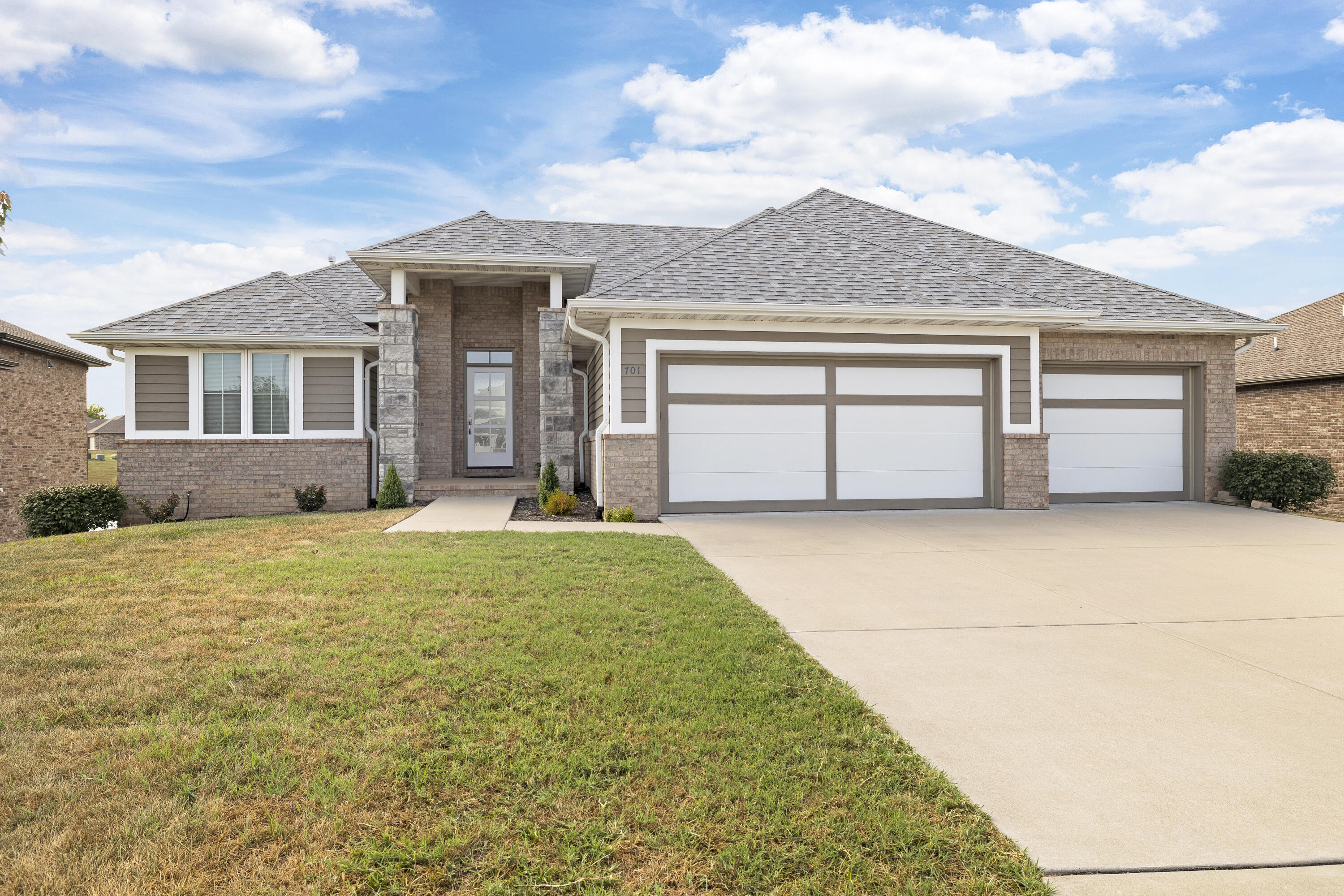 Immaculate walk-out basement home with water view in Wicklow!! Featuring SIX bedrooms and three full bathrooms this all brick home is ready to go! This split bedroom floorplan is wonderful, inviting, and full of natural light. As you enter into the home from the covered front porch you will notice the large living room with high ceilings and beautiful gas fireplace. Open-concept eat in kitchen with bar, gas range, and stainless steel appliances. Dining room off of the kitchen with windows overlooking pond and fountain. Enjoy your morning coffee on the covered and screened in back porch. Large pantry, mud room, and laundry space off of the three car garage on the primary bedroom side. The primary bedroom features large walk in closet, tiled walk in shower and double vanity. Two more bedrooms with full bath are upstairs. Downstairs you will find brand new luxury vinyl plank flooring throughout. Three full bedrooms with full bath downstairs with wet bar. Large living spaces downstairs with storage areas and walk out access to back covered patio and large fenced yard. This home checks all of the boxes, do not miss your opportunity!