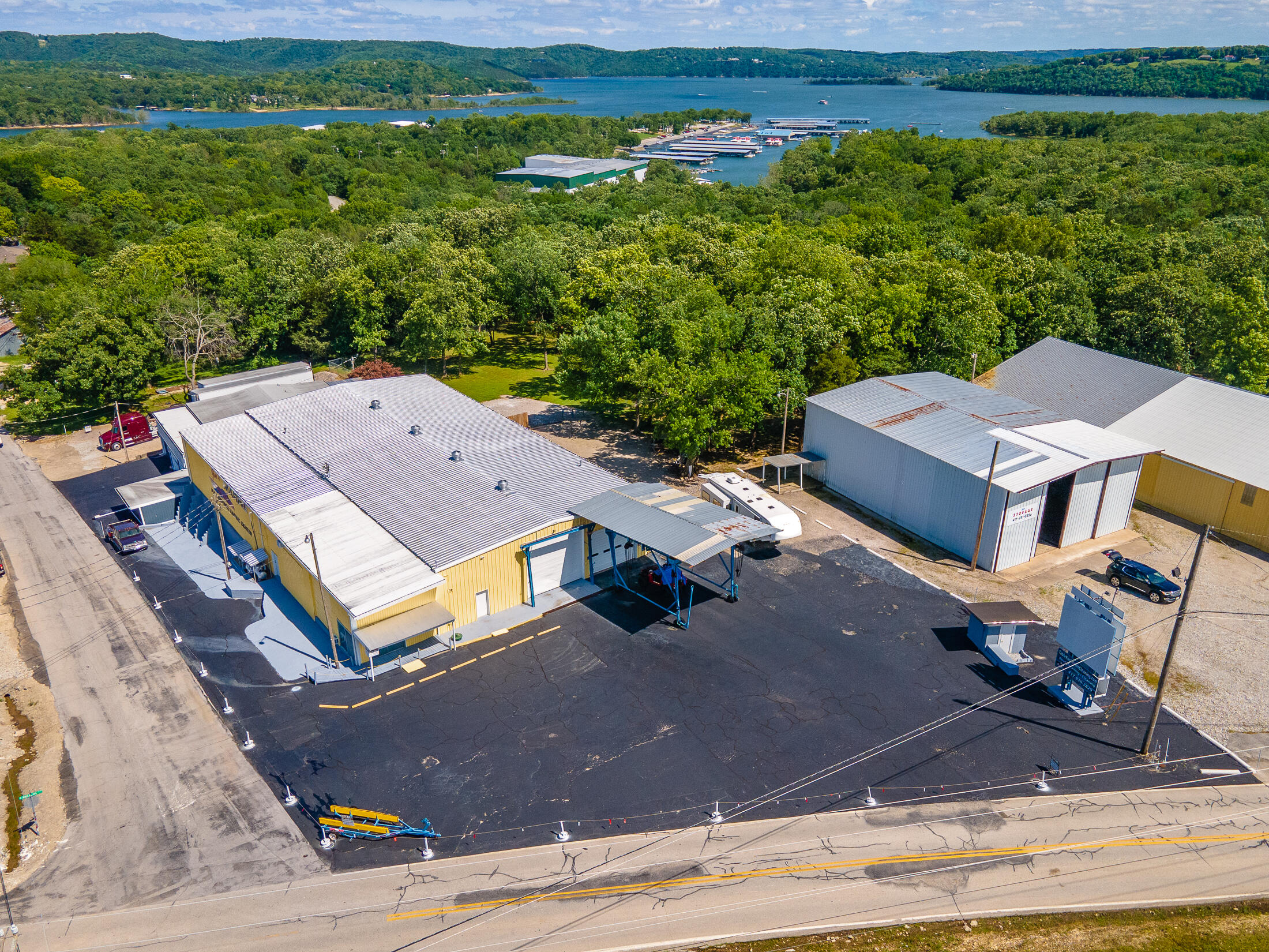 Truly unique....industrial land in Kimberling City. Perfect for manufacturing or service business. 10,000+ sq ft of space. There is office space available on the upper level as well as a showroom with overhead door, ample parking, 3 phase power and great location near Port of Kimberling. Over 130 ft of Kimberling Blvd frontage with additional frontage on Bass Ave. Multiple overhead doors with high clearances.