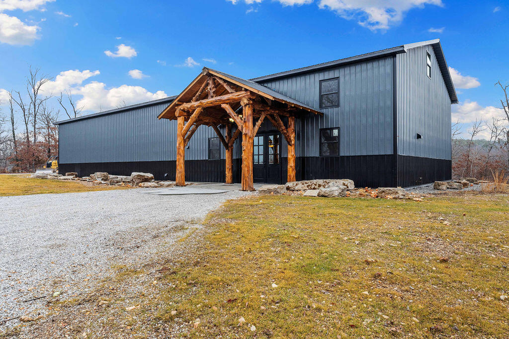 One of a kind Barndominium. Rustic meets luxurious , Low maintenance,  40 x 100 with 2 story, approximately 3500 sq ft living area. The 2-story living area is approximately 3500 sq. ft. and includes 4 bedrooms, 3 1/2 baths, 2 living areas and a bonus room.  The main floor has an open floor plan with tall ceilings and loads of upgrades. The kitchen features custom cabinetry, a pantry and granite countertops, which is open to the great room that boasts a bar area and cozy wood stove.  Two of the baths have jetted tubs and large walk in closets with lots of additional storage. The attached, oversized garage is 38x 40 , with tall ceilings  and doors and will provide all the space one needs for the largest RV with plenty of space left over for all of your vehicles and toys, plus an additional shop area . Only about 1000 feet to the Missouri Conservation area.All on 3 surveyed acres which is a 20-minute drive to Bella Vista, which is quickly becoming the Mountain Biking capital of the Midwest.  Located in beautiful southwest Missouri, where the streams are clear for great Kayaking and just down the road from Rush Springs Ranch recreation area.Just 6 miles to the 340 & 94 Junction and 15 minutes to Bella Vista town center. It's an easy drive to Bentonville, Arkansas (Wal Mart Headquarters)  with terrific shopping and eateries in Northwest Arkansas.  Or a short drive to Joplin , Mo.