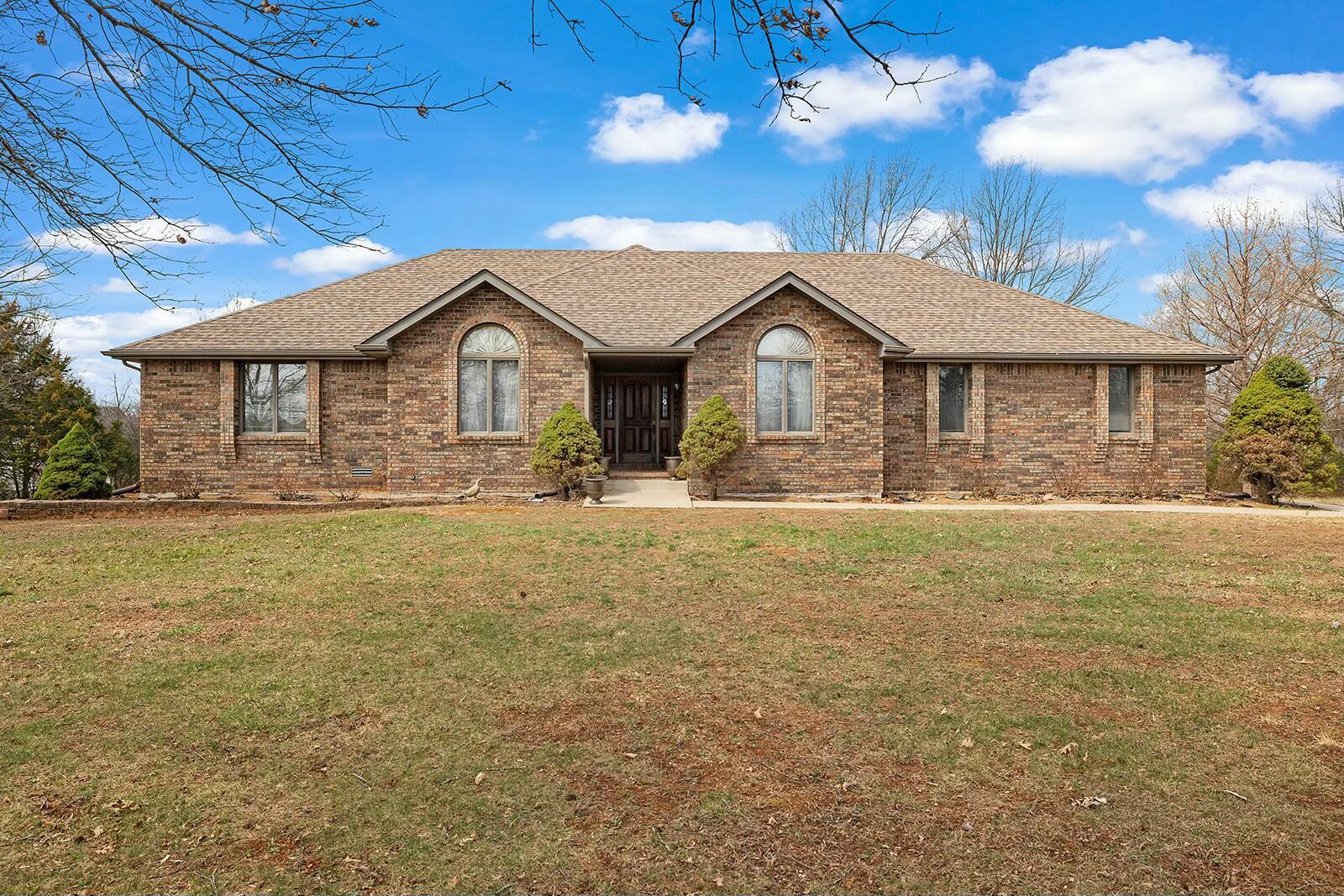Nestled on a picturesque 4.96-acre lot, this immaculate, all-brick home offers a rare blend of quality craftsmanship, space, and convenience. Built in 1989 and meticulously maintained, this one-owner home features 4 spacious bedrooms and 3 full bathrooms, providing ample room for family and guests.The walkout basement adds versatility, perfect for additional living space, recreation, or storage. Outside, you'll find a large barn/workshop, ideal for hobbies, storage, or animals, plus a dedicated garden area for those who love to grow their own produce.New water heater in 2021, furnace and dishwasher in 2023, A/C unit in 2024. Located in a highly desirable area, this property offers the perfect balance of privacy and accessibility. Whether you're looking for a serene country retreat or a functional homestead, this home is a must-see!